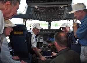 Capt. Ryan Daugherty explains the inner workings of a C-17 to a group of World War II veterans June 29. The veterans were pilots and ground crew members from the 493rd Fighter Squadron. Captain Daugherty is a pilot with the 16th Airlift Squadron. (U.S. Air Force photo/Staff Sgt. Daniel Bowles)