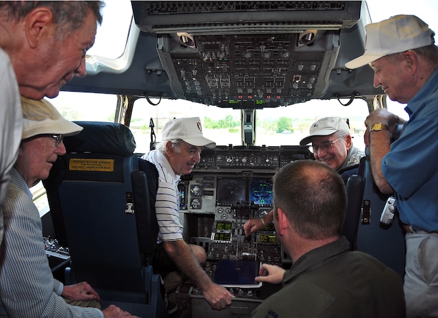 Capt. Ryan Daugherty explains the inner workings of a C-17 to a group of World War II veterans June 29. The veterans were pilots and ground crew members from the 493rd Fighter Squadron. Captain Daugherty is a pilot with the 16th Airlift Squadron. (U.S. Air Force photo/Staff Sgt. Daniel Bowles)