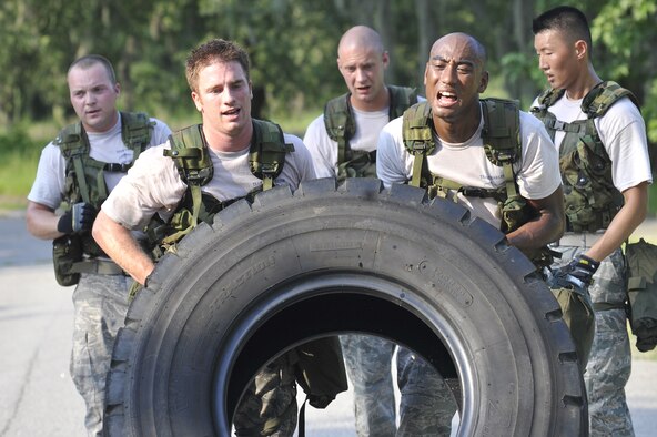 Senior Airman James Tench, left, and Senior Airman Luther Franklin flip a tire during an obstacle course held here June 24. The Airmen and their team are building their endurance for the Rodeo 2009 readiness competition scheduled to be held at McChord AFB, Wash., July 19-25. Rodeo 2009 is expected to draw more than 100 teams and 2,500 people from the Air Force and Air Force Reserve, as well as allied nations. The Airmen are air transportation specialists with the 437th Aerial Port Squadron. (U.S. Air Force photo/James M. Bowman) (RELEASED)