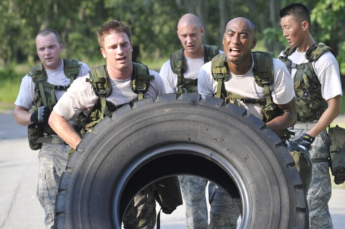 Senior Airman James Tench, left, and Senior Airman Luther Franklin flip a tire during an obstacle course held here June 24. The Airmen and their team are building their endurance for the Rodeo 2009 readiness competition scheduled to be held at McChord AFB, Wash., July 19-25. Rodeo 2009 is expected to draw more than 100 teams and 2,500 people from the Air Force and Air Force Reserve, as well as allied nations. The Airmen are air transportation specialists with the 437th Aerial Port Squadron. (U.S. Air Force photo/James M. Bowman) (RELEASED)