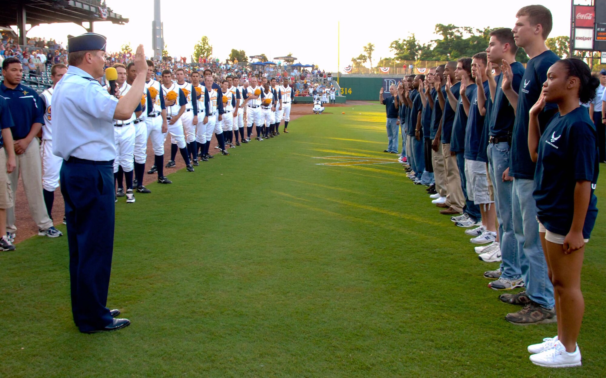 Members of the 331st Recruiting Squadron Delayed Enlistment Program take the Air Force oath of enlistment at the Montgomery Biscuits annual Military Appreciation Night baseball game June 13. Maj. Gen. Maury Forsyth, Spaatz Center commander, administered the oath. (U.S. Air Force photo/Donna Burnett)