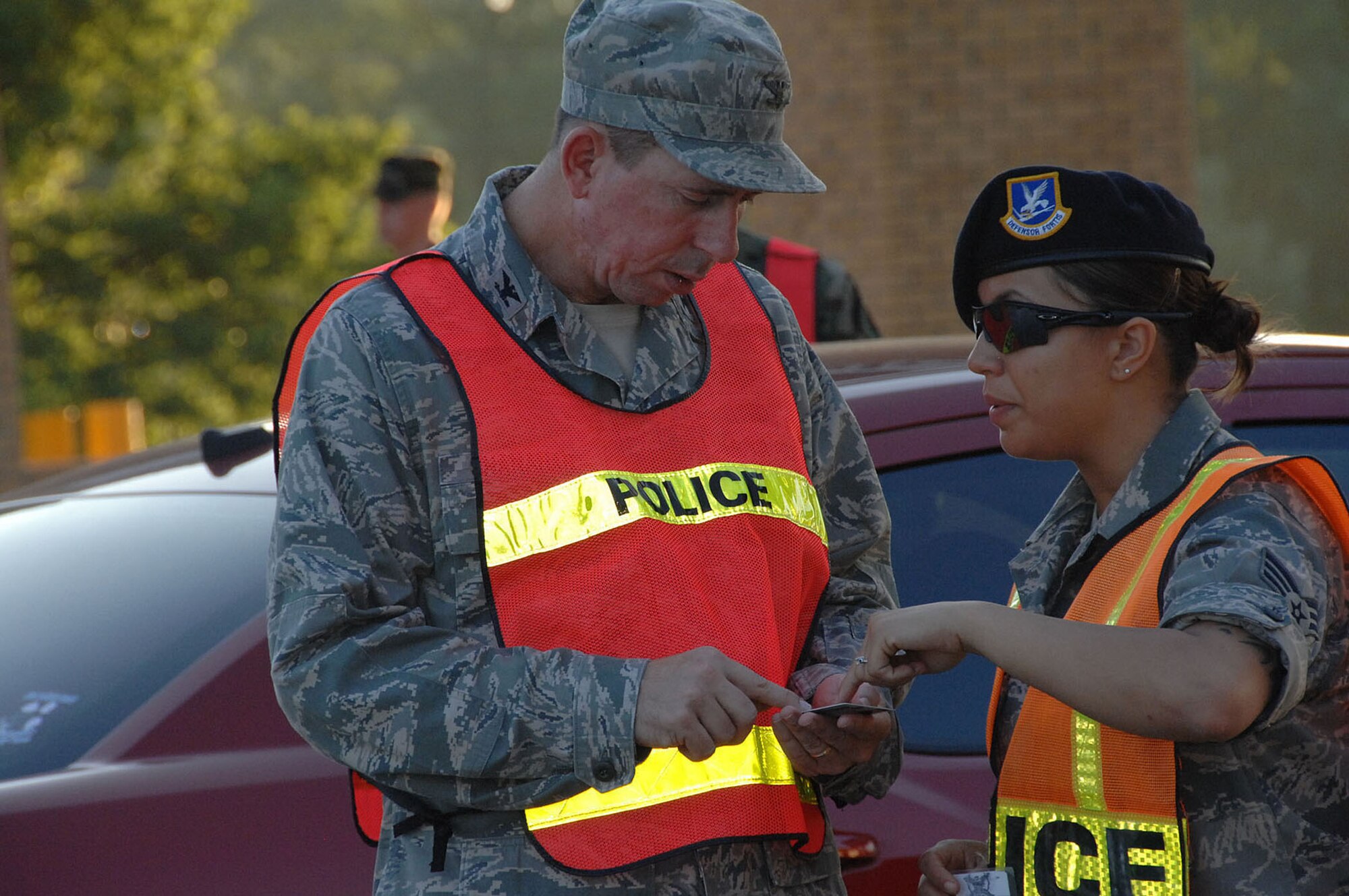 OFFUTT AIR FORCE BASE, Neb. -- Then-Colonel John N.T. Shanahan, 55th Wing commander, receives clarification on the differences of the Department of Defense common access cards from Senior Airman Ashley Jankowski, 55th Security Forces Squadron, at the SAC Gate June 25.The commander, who was recently promoted to brigadier general, inspected ID cards at the gate to help ensure only authorized individuals gain access to the base.

U.S. Air Force photo by Kendra Williams
