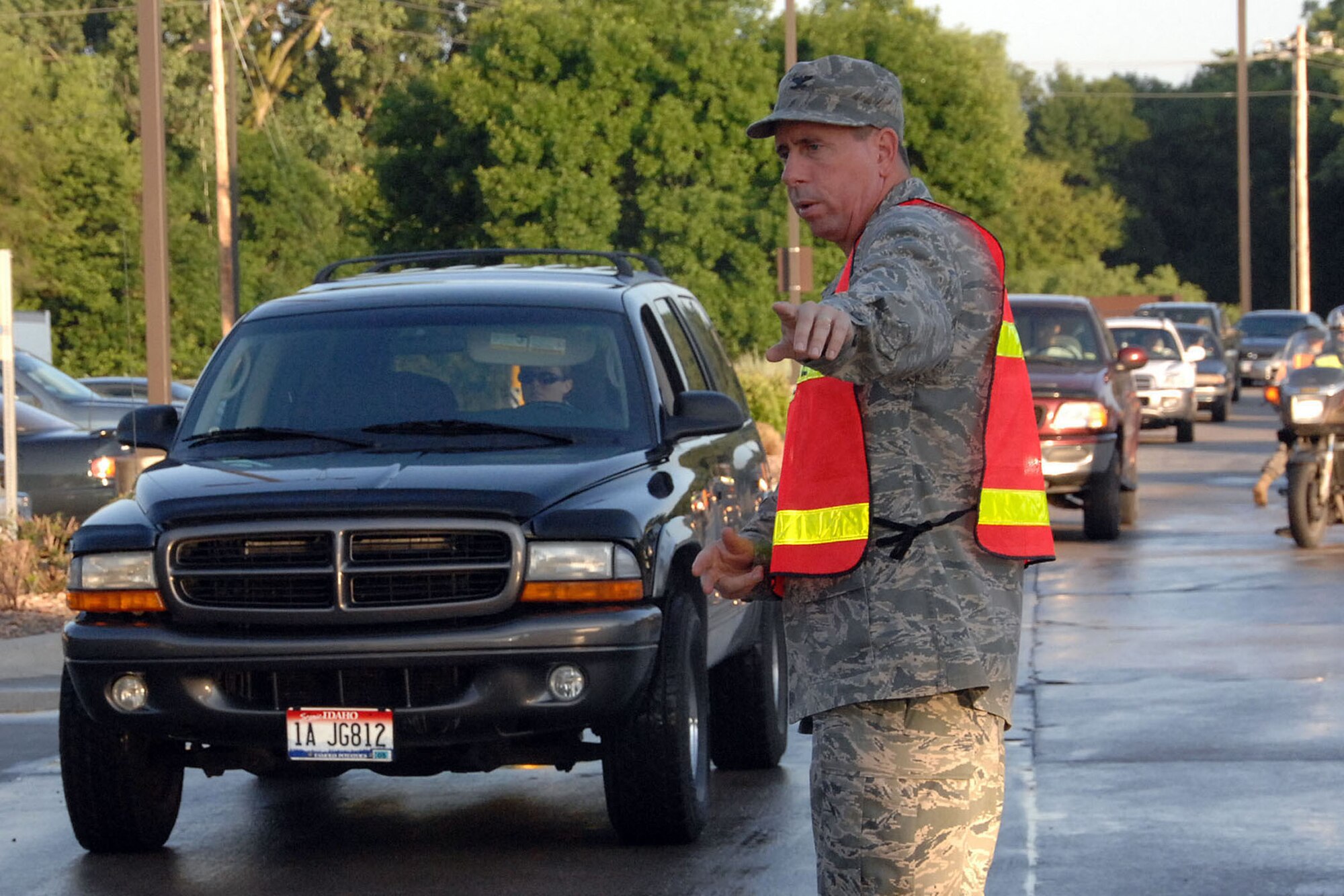 OFFUTT AIR FORCE BASE, Neb. -- Then-Colonel John N.T. Shanahan, 55th Wing commander, directs traffic through the SAC Gate during his morning gate augmentee duty June 25. The commander, who was recently promoted to brigadier general, inspected ID cards at the gate to help ensure only authorized individuals gain access to the base.

U.S. Air Force photo by Kendra Williams 