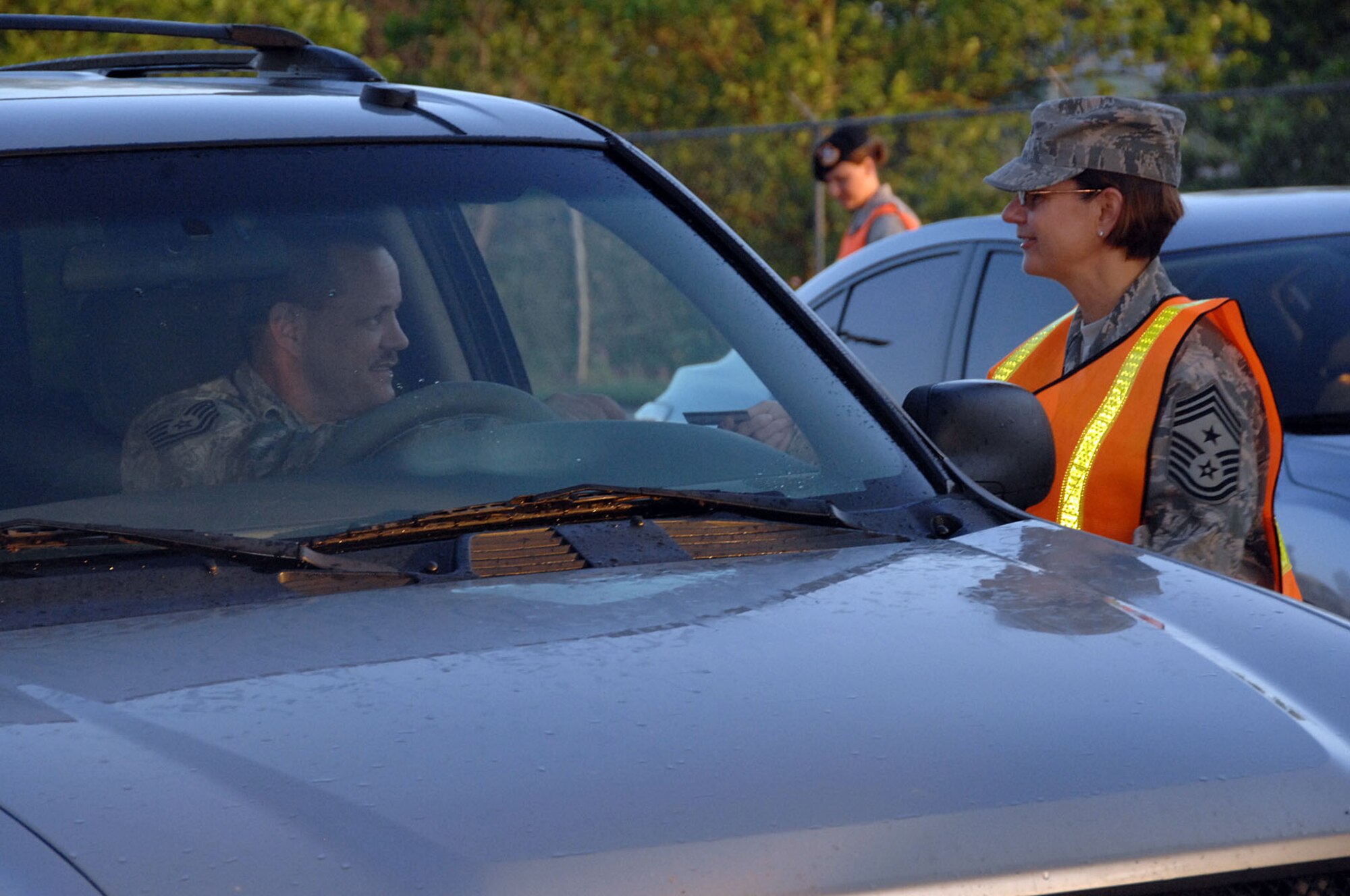 OFFUTT AIR FORCE BASE, Neb. -- Command Chief Master Sgt. Lisa Sirois, 55th Wing Command Chief, checks common access cards at the SAC Gate during augmentee duty June 25. Security augmentees are used to assist with the steady flow of entry traffic to minumize delays. 

U.S. Air Force photo by Kendra Williams 