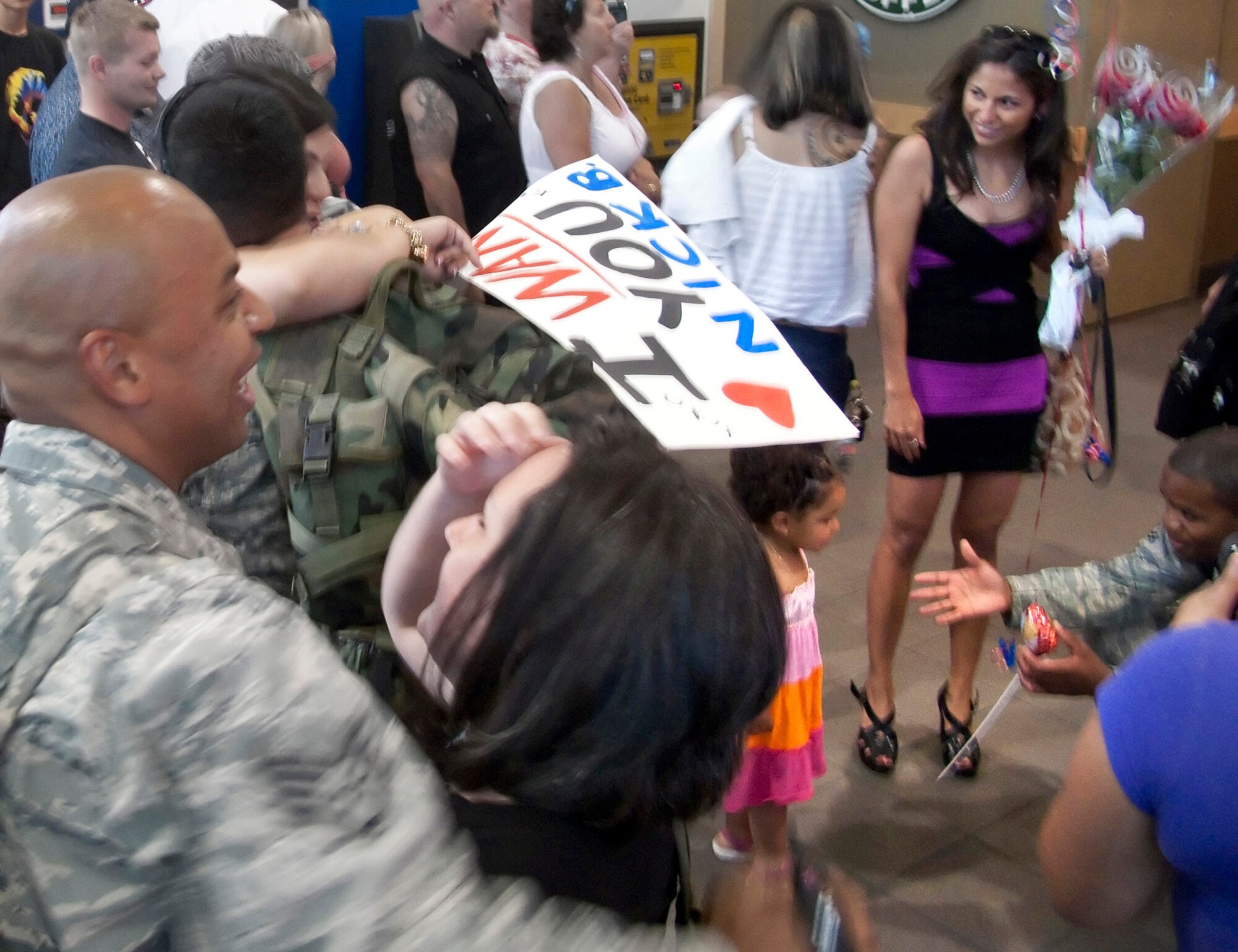 TRAVIS AIR FORCE BASE, Calif. -- Family and friends greet 13 Air Force Reservists returning to Sacramento International Airport from duty in Iraq June 27.  The Airmen from the 349th Security Forces Squadron had been away from Northern California for more than six months, performing air base defense and law enforcement duties at Kirkuk Air Base, Iraq.  (U.S. Air Force photo / Maj. Robert Couse-Baker)