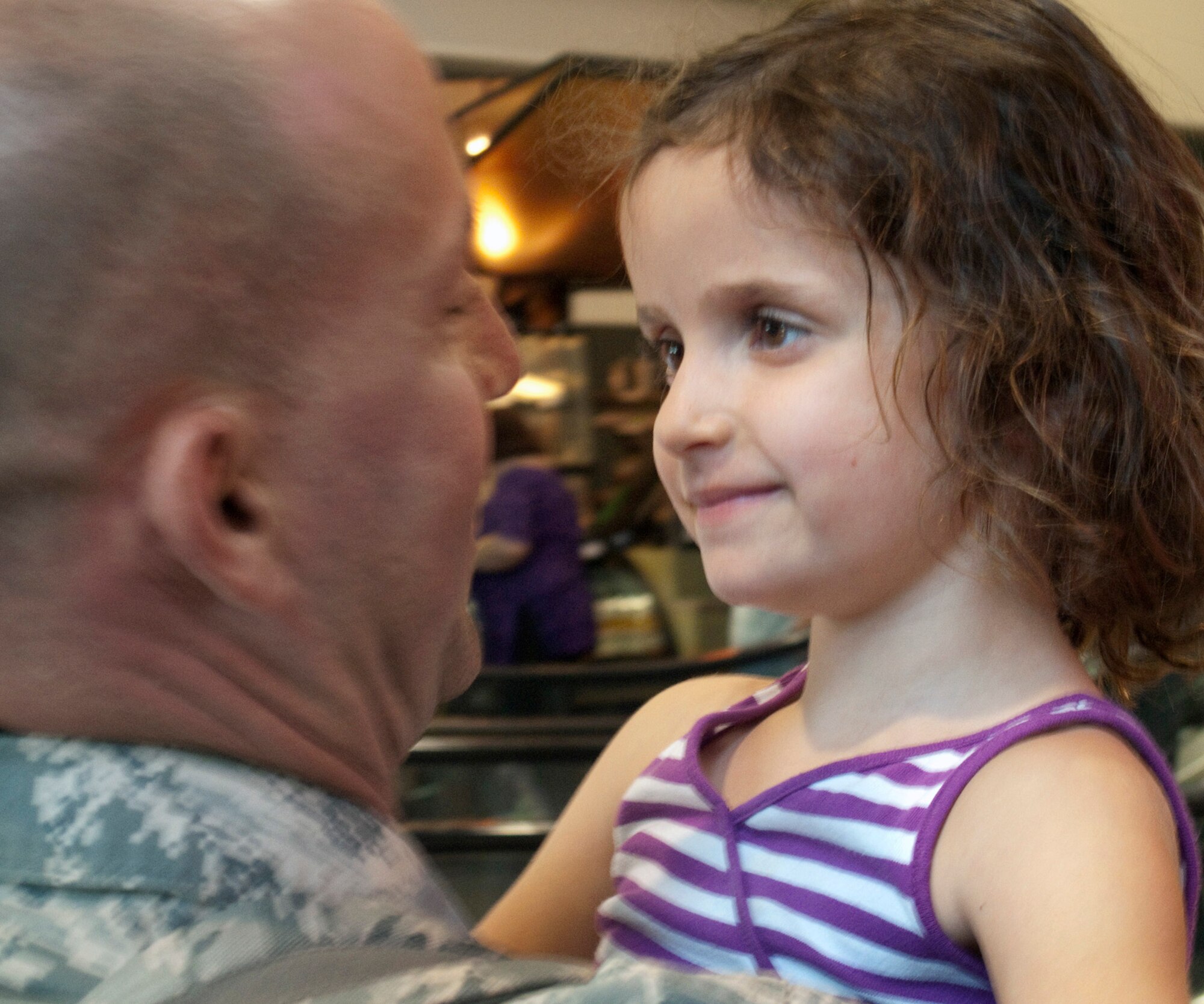 TRAVIS AIR FORCE, Calif, -- Master Sgt. Ron Dockswell's daughter welcomes him back as family and friends greet 13 Air Force Reservists returning to Sacramento International Airport from duty in Iraq June 27. The Airmen from the 349th Security Forces Squadron had been away from Northern California for more than six months, performing air base defense and law enforcement duties at Kirkuk Air Base, Iraq.  (U.S. Air Force photo / Maj. Robert Couse-Baker)