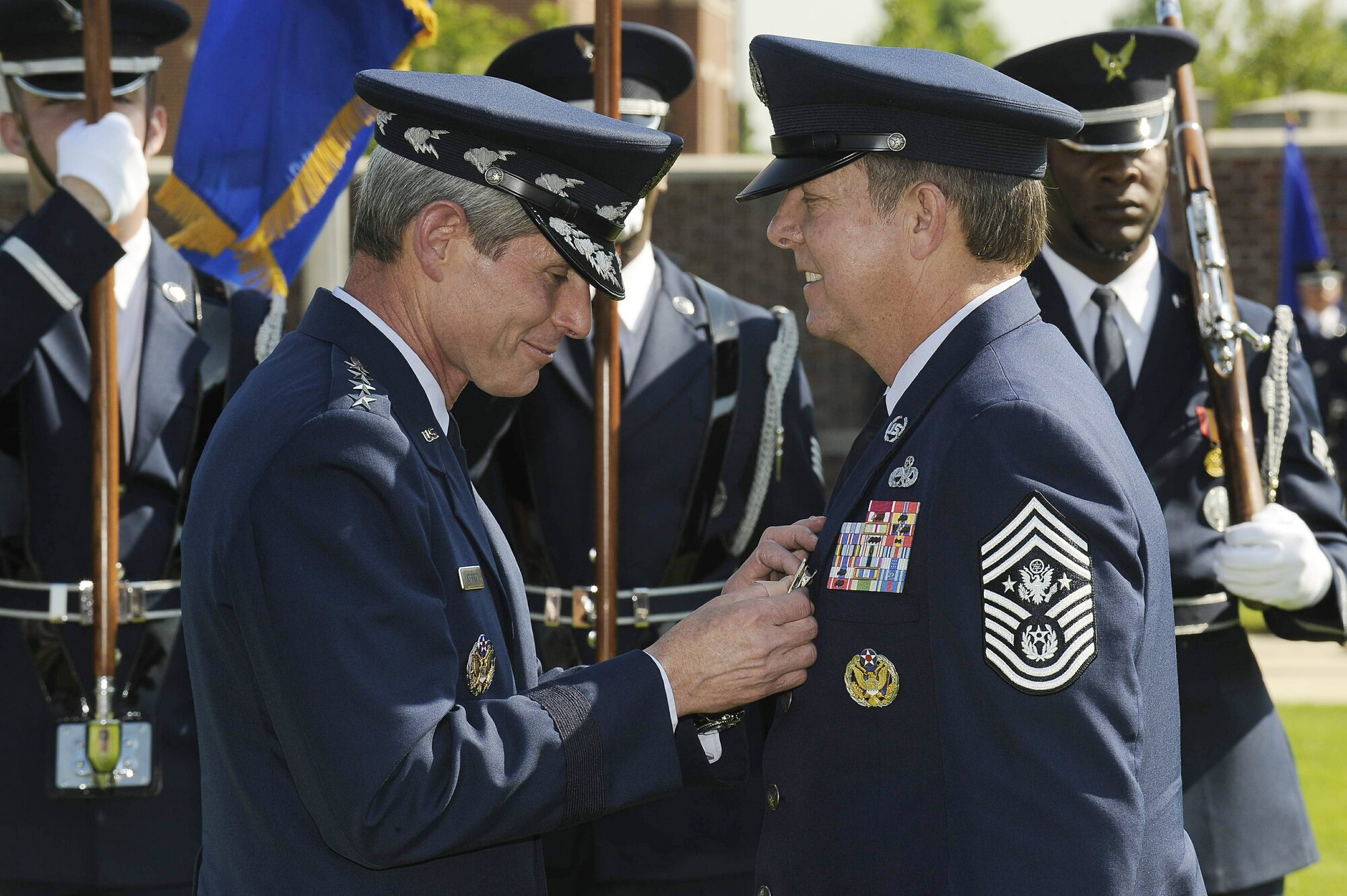 Air Force Chief of Staff Gen. Norton Schwartz pins the Distinguished Service Medal on Chief Master Sgt. of the Air Force Rodney J. McKinley during his retirement ceremony June 30 at Bolling Air Force Base, D.C. Chief McKinley retired and Chief Master Sgt. of the Air Force James A. Roy was appointed as the Air Force's 16th top enlisted leader. (U.S. Air Force photo/Scott Ash)