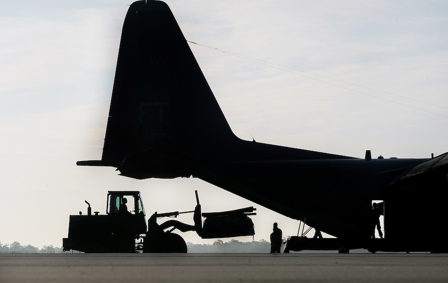 MOODY AIR FORCE BASE, Ga. -- Airmen from the 71st Rescue Squadron load cargo
onto the back of a HC-130P Combat King prior to departure here July 1. It will be the first time Combat Kings will participate in Talisman Saber, a multinational exercise held every two years. (U.S. photo by Airman 1st Class Joshua Green)
