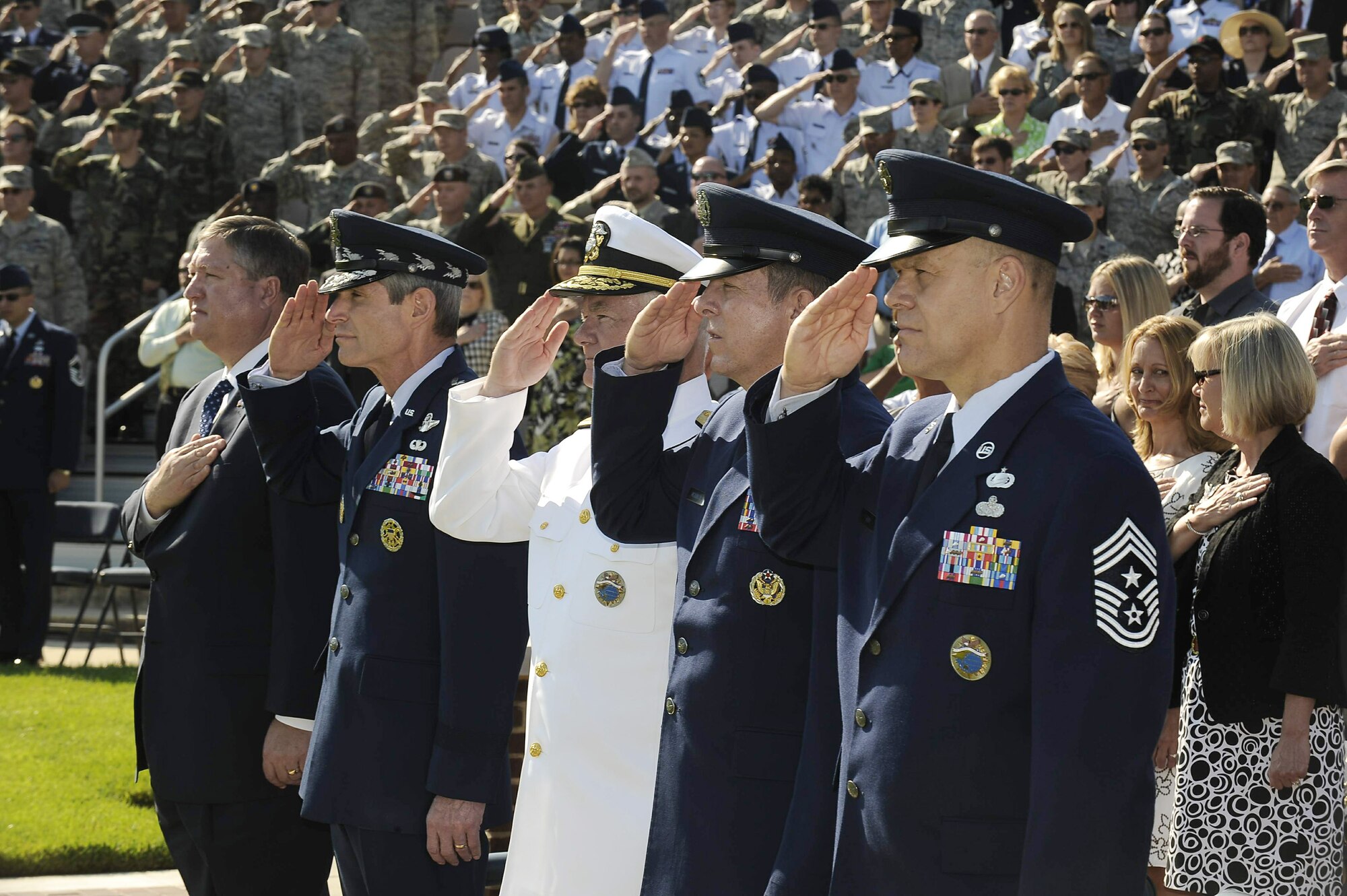 Military leaders salute the flag during the national anthem at the retirement ceremony for Chief Master Sgt. of the Air Force Rodney J. McKinley June 30 at Bolling Air Force Base, D.C. Chief McKinley retired and Chief Master Sgt. of the Air Force James A. Roy was appointed as the Air Force's 16th top enlisted leader. (U.S. Air Force photo/Scott Ash)