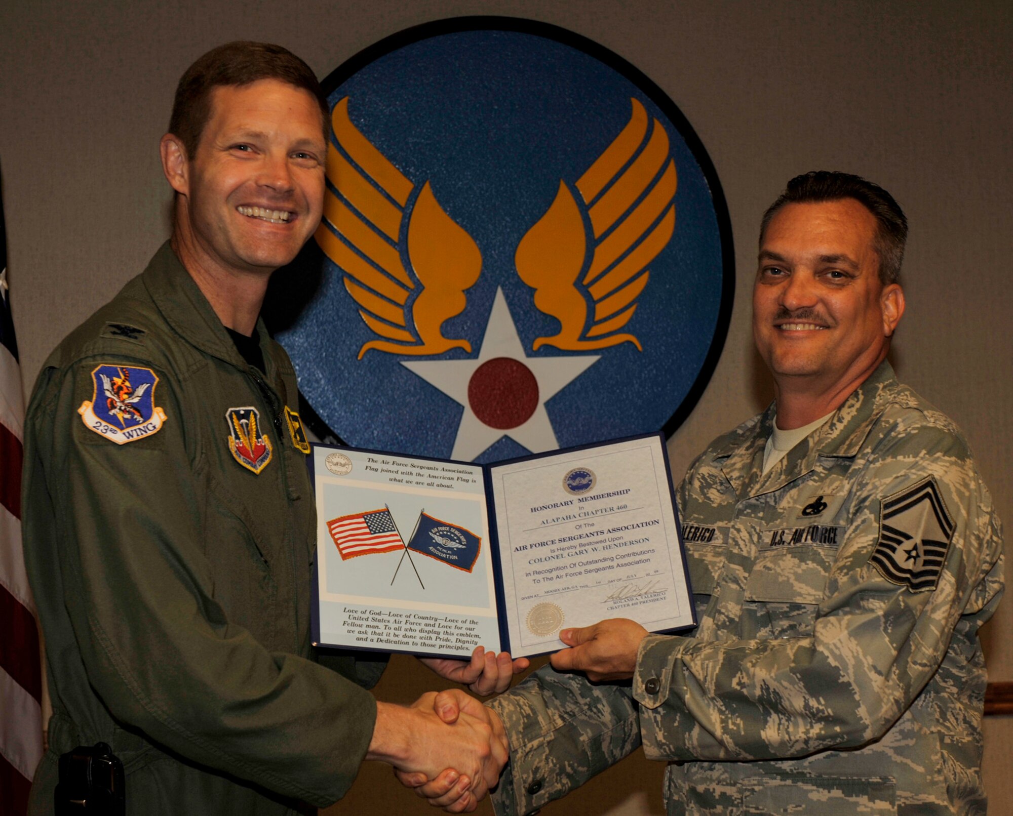 MOODY AIR FORCE BASE, Ga. -- Senior Master Sgt. Roland Talerico, president of the Air Force Sergeants Association, Chapter 460, presents Col. Gary Henderson, 23rd Wing commander, an honorary membership to AFSA. The AFSA is a non-profit organization representing the professional and personal interests of 125,000 active duty, retired and veteran enlisted members of the U.S. Air Force, Air National Guard and Air Force Reserve Command. (U.S. Air Force photo by Senior Airman Schelli Jones)