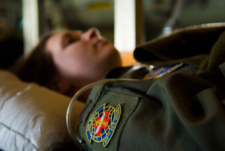 An Airman with the 109th Aeromedical Evacuation Squadron plays the role of a simulated patient in the cargo bay of a C-130 Hercules aircraft flying over Volk Field, Wis., May 16, 2009. Hundreds of men and women from the Minnesota Air National Guard joined Airmen from Scott Air Force Base, Ill., for exercise Readiness Safeguard in preparation for an operational readiness inspection. (U.S. Air Force photo by Tech. Sgt. Erik Gudmundson/Released)
