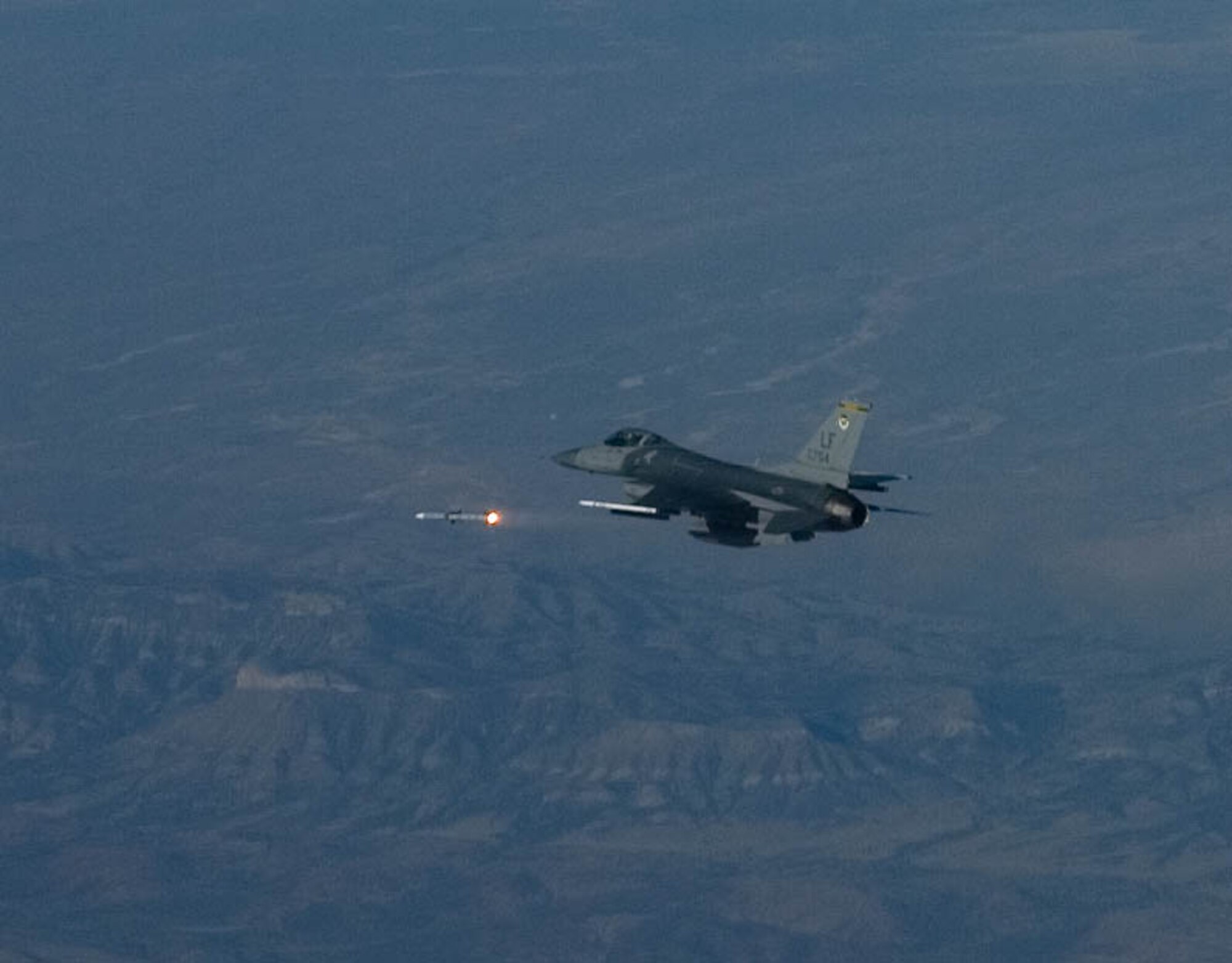 An F-16 Fighting Falcon from the 310th Fighter Squadron fires off a missle during a QF-4 drone shootout exercise over the White Sands Missle Range in New Mexico, June 18. 