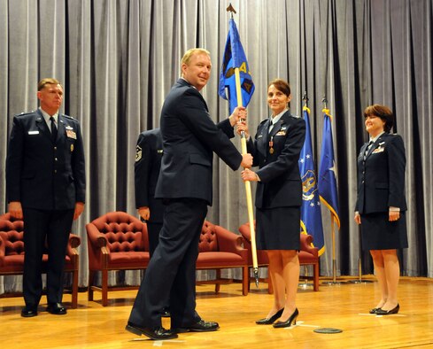 NIAGARA FALLS AIR RESERVE STATION, N.Y. --  Col. Patricia A. Jarmuz (center) receives the 914th Aeromedical Staging Squadron (ASTS) guidon during a change of command ceremony at the James Roberts theater here May 2, 2009. Col. Jarmuz formally assumed command of the 914th ASTS from Col. Renata T. Sierzega (right), who commanded the unit for nine years. Former 914th Airlift Wing commander Brig. Gen. Wallace T. "Wade" Farris (left) presided over the ceremony, which included Col. Sierzega's retirement after more than 30 years of service.  (U.S. Air Force photo by Staff Sgt. Daniel Lanphear)