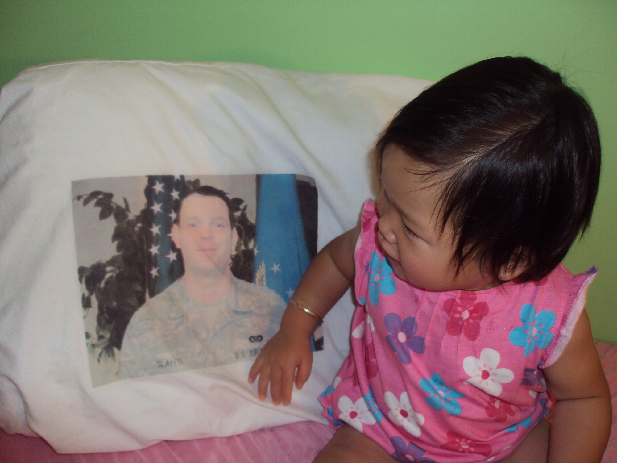 WRIGHT-PATTERSON AIR FORCE BASE, Ohio - Senior Airman Andrew Slahta, 445th Security Forces Squadron, currently deployed, can't wait to see his daughter, Makenna, shown here with a pillow of Airman Slahta imprinted on it, for the first time.
(courtesy photo)