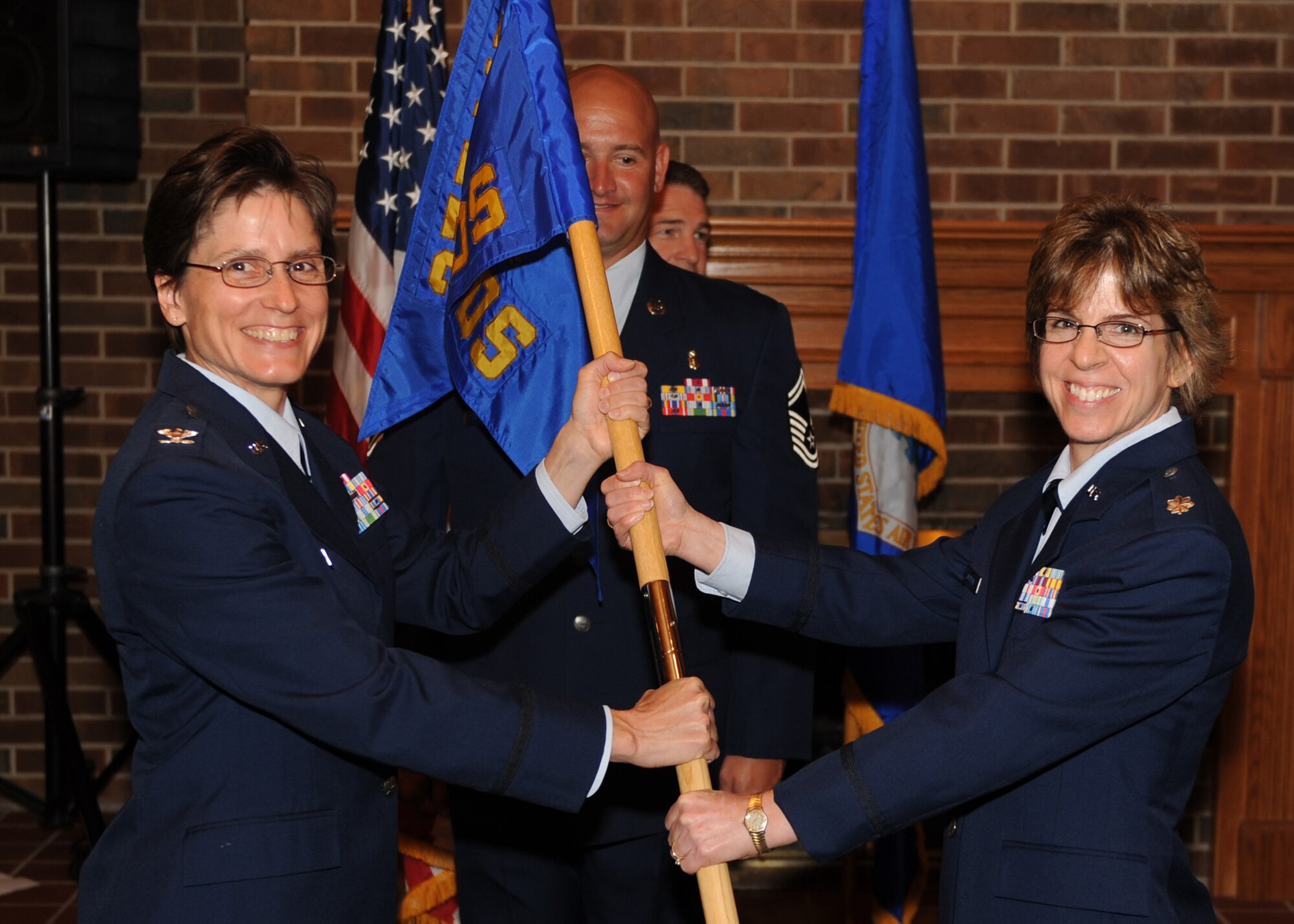 SCOTT AIR FORCE BASE, Ill. -- Colonel Sterling passes the guidon to Lt. Col. Alice Chapman, the new 375th Aerospace Medicine Squadron commander, Tuesday at the Cardinal Creek Golf Course. Colonel Chapman took command of the 375th AMDS from Lt. Col. Gregory Durand. (U.S. Air Force photo/ Airman 1st Class Wesley Farnsworth)