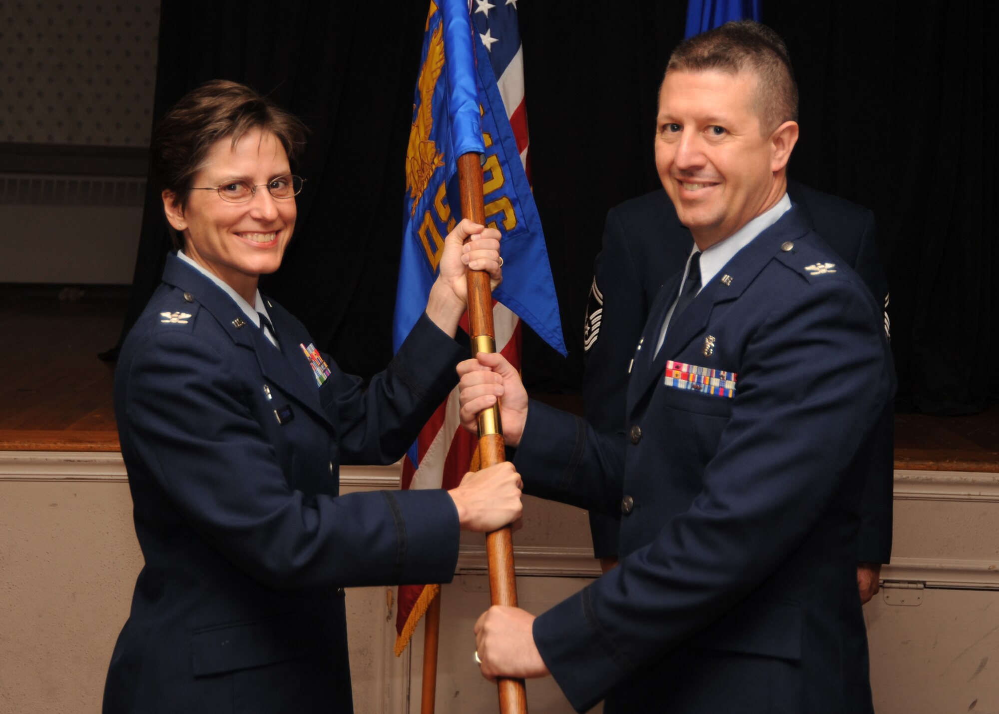 SCOTT AIR FORCE BASE, Ill. -- Col. Jill Sterling, 375th Medical Group commander, hands the 375th Dental Squadron guidon to Col. Scott Schubkegel during the 375th DS change of command ceremony June 25. Colonel Schubkegel took command of the 375th DS from Col. William Buhler.(U.S. Air Force photo/ Airman 1st Class Wesley Farnsworth)