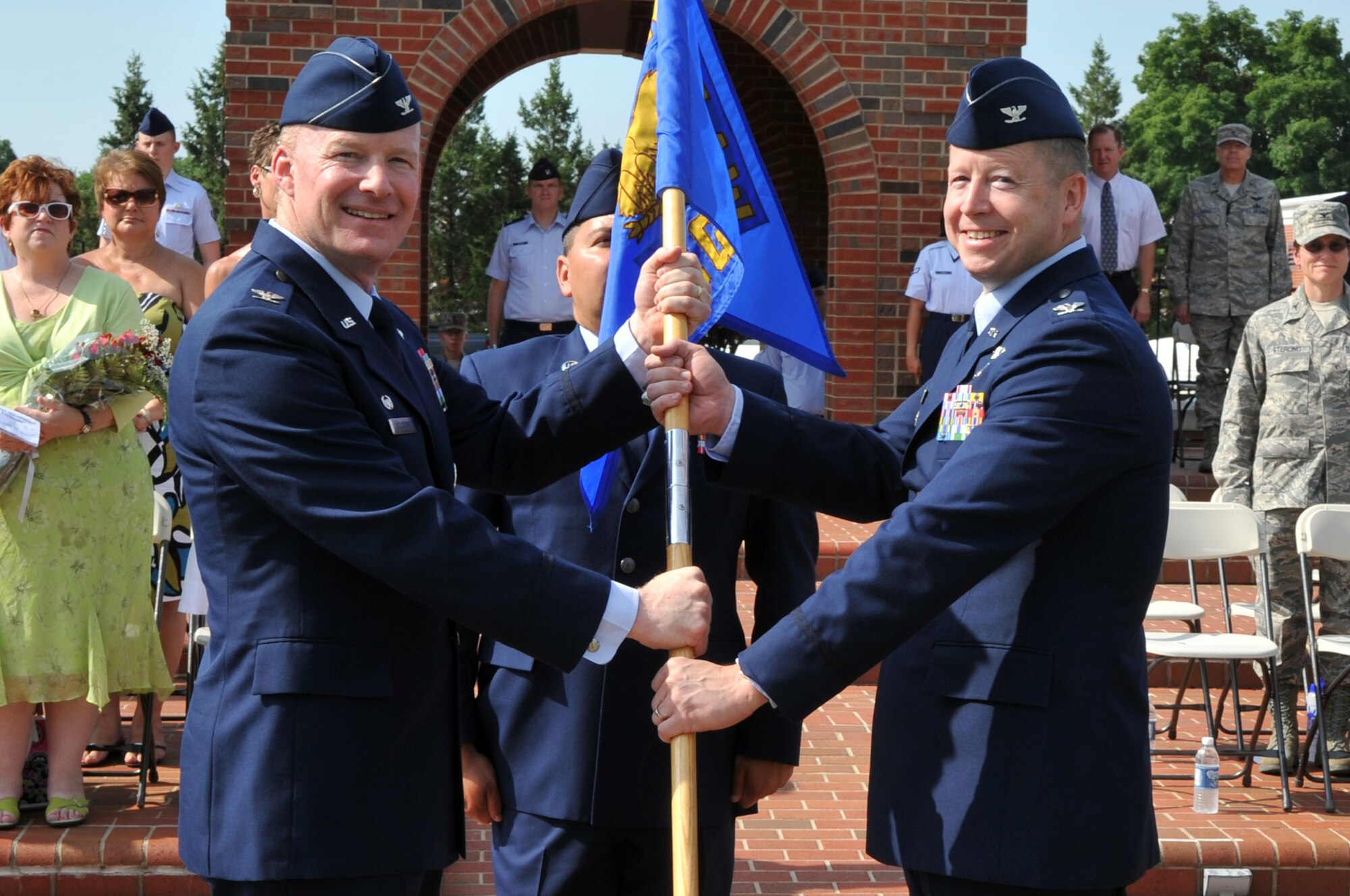 SCOTT AIR FORCE BASE, Ill. -- Col. Gary Goldstone, 375th Airlift Wing commander, passes the guidon to Col. Dennis Simpson during the 375th Communications Group change of command Friday. Colonel Simpson comes to Scott from Headquarters Air Combat Command, Langley Air Force Base, Va.(U.S. Air Force photo/ Senior Airman Teresa Hawkins)