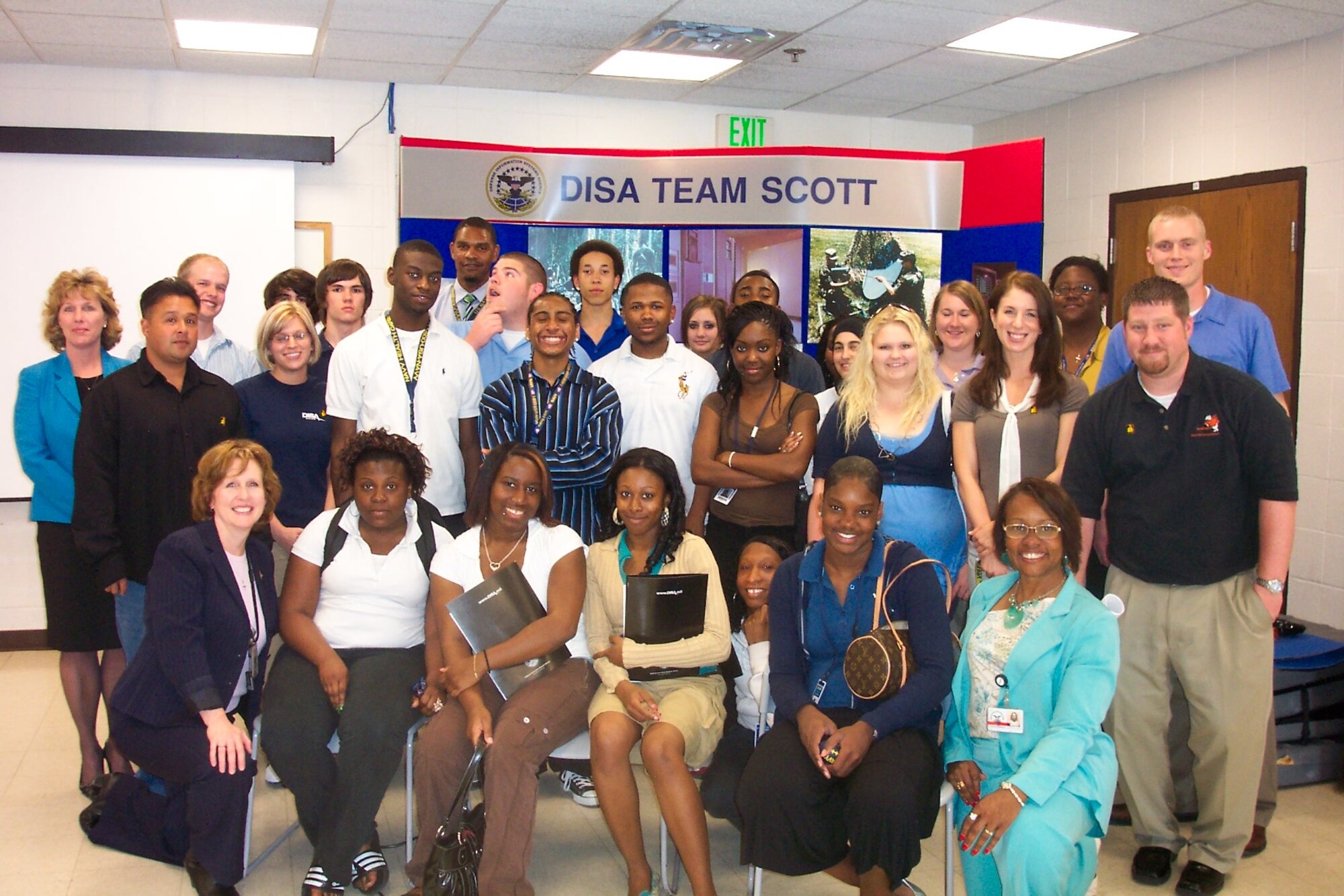 SCOTT AIR FORCE BASE, Ill. -- Twenty-two students from Belleville East High School and their teacher, Kimberly Burch, visited Scott for the day.  The students received briefings about nursing, law, procurement, finance, information technology and student programs given by the Defense Information Systems Agency. Team Scott and Navy Lt. Cmdr. Christopher Cesa, from U.S. Transportation Command’s Surgeon General’s Office, along with recruiting staff members gave them a base tour and took them to lunch at the Nightingale Inn Dining Facility. (Courtesy photo)