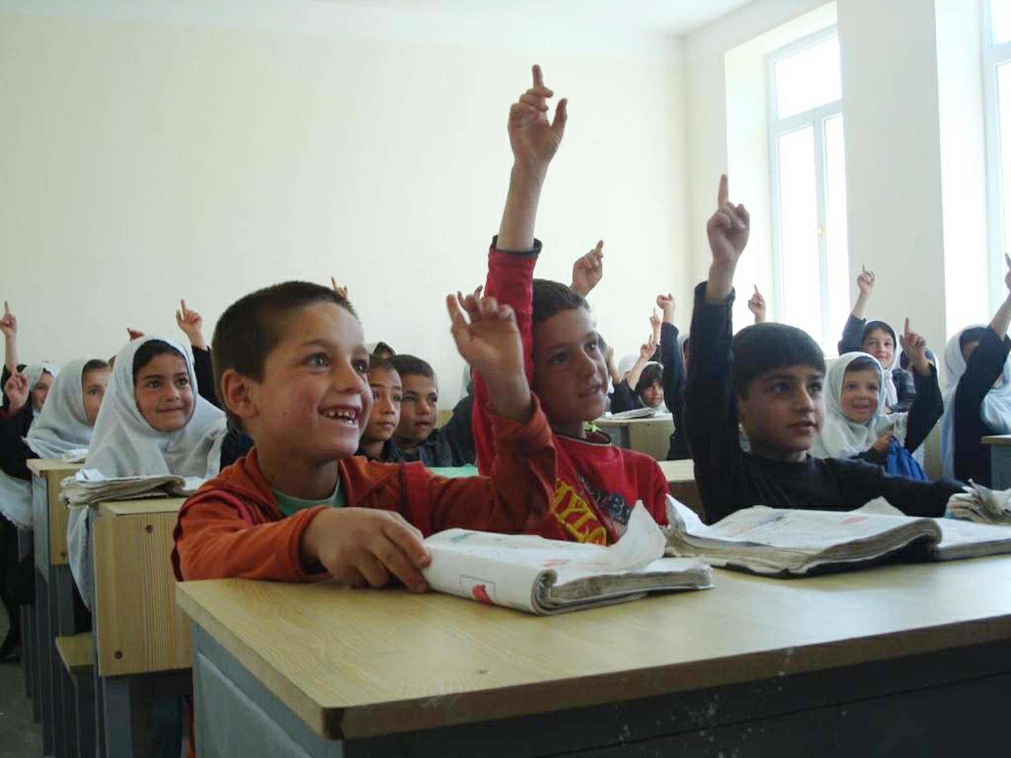 First graders at the newly-opened Provincial Reconstruction Team Panjshir-funded Haish Saidqi Girls' School answer questions about what they want to be when they grow up June 23 in the Panjshir Province, Afghanistan. Although officially a girls' school, a small number of boys attend as well. The school will serve more than 500 girls from nearby villages. (U.S. Air Force photo/Capt. Stacie N. Shafran) 
