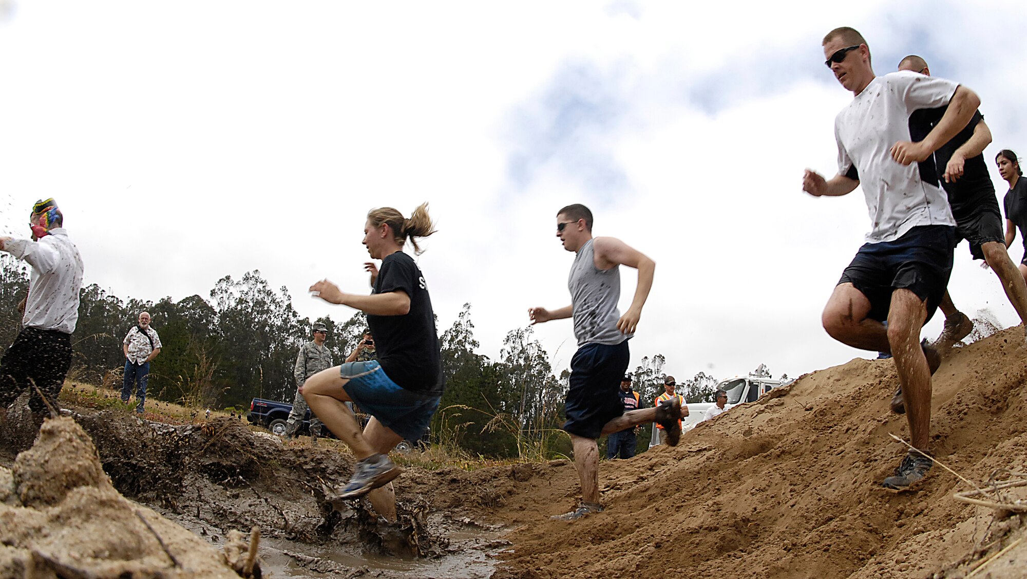 VANDENBERG AIR FORCE BASE, Calif. -- Members of Team V take part in the Vandenberg Warrior Challenge Mud Run on June 30 here. Approximately 1,200 runners took on the five-mile course, which covered paved roads, off-road vehicle trails and the base obstacle course. Sixty teams participated in the event. (U.S. Air Force photo/Staff Sgt. Vanessa Valentine)