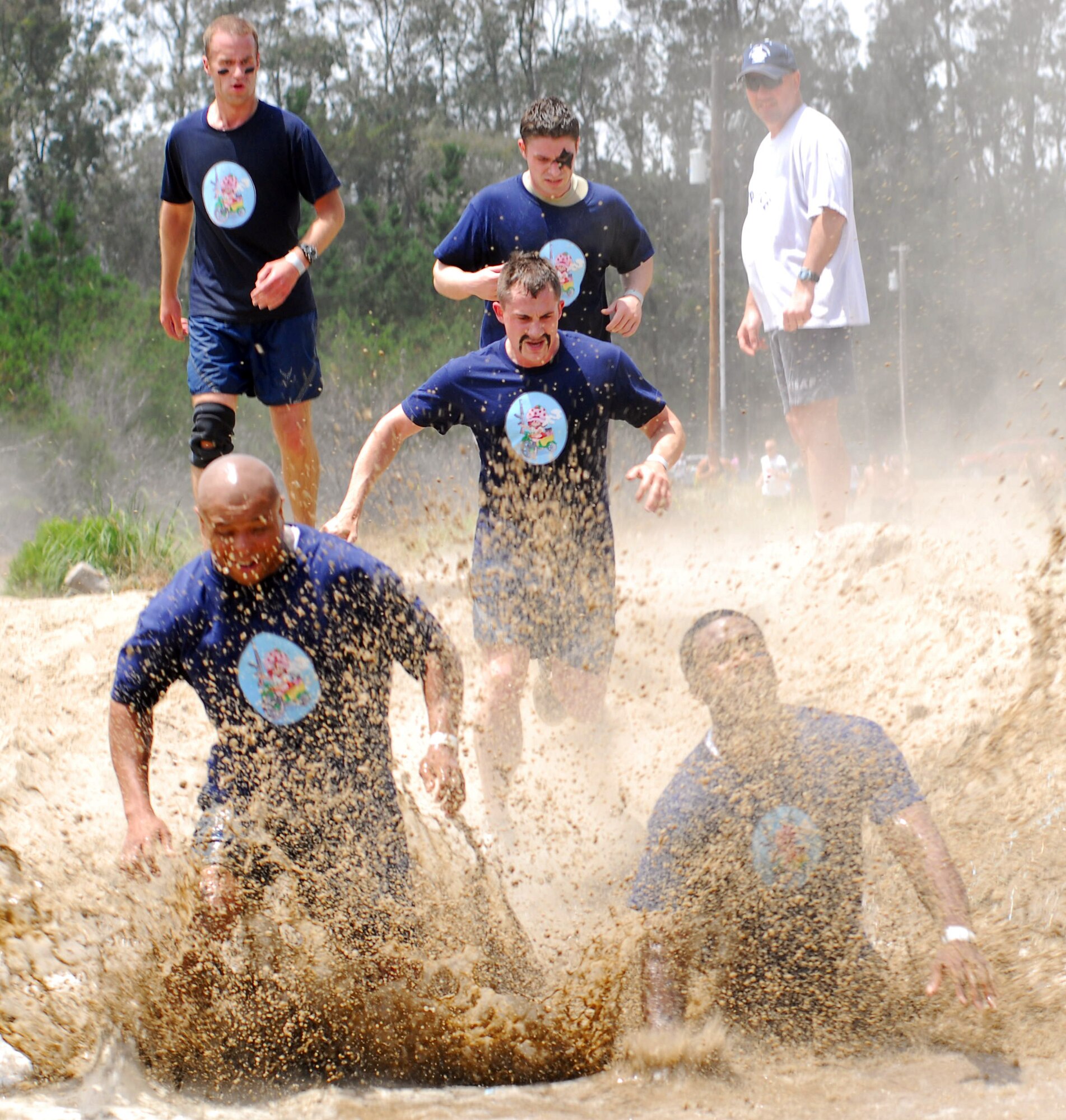 VANDENBERG AIR FORCE BASE, Calif. -- Hitting the pit running, members of Team V take part in the Vandenberg Warrior Challenge Mud Run on June 30 at Cocheo Park here. “The course was designed to test the physical and mental toughness needed to build warrior ethos, which is the foundation of what it means to be an Airman," said Master Sgt. Patrick Dutkevitch, the Vandenberg Mud Run coordinator. (U.S. Air Force photo/Airman 1st Class Kerelin Molina) 