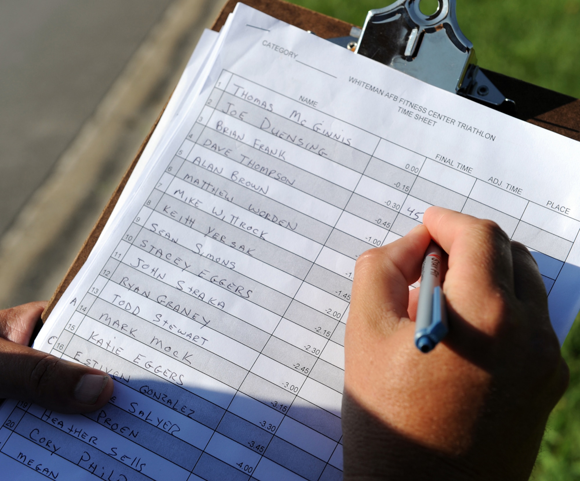 WHITEMAN AIR FORCE BASE, Mo. -  Mr. Gregory Hauser, Whiteman Fitness Center director, documents the completion times of the triathlon’s tri-athletes as they finished the event.  (U.S. Air Force photo/Senior Airman Cory Todd)