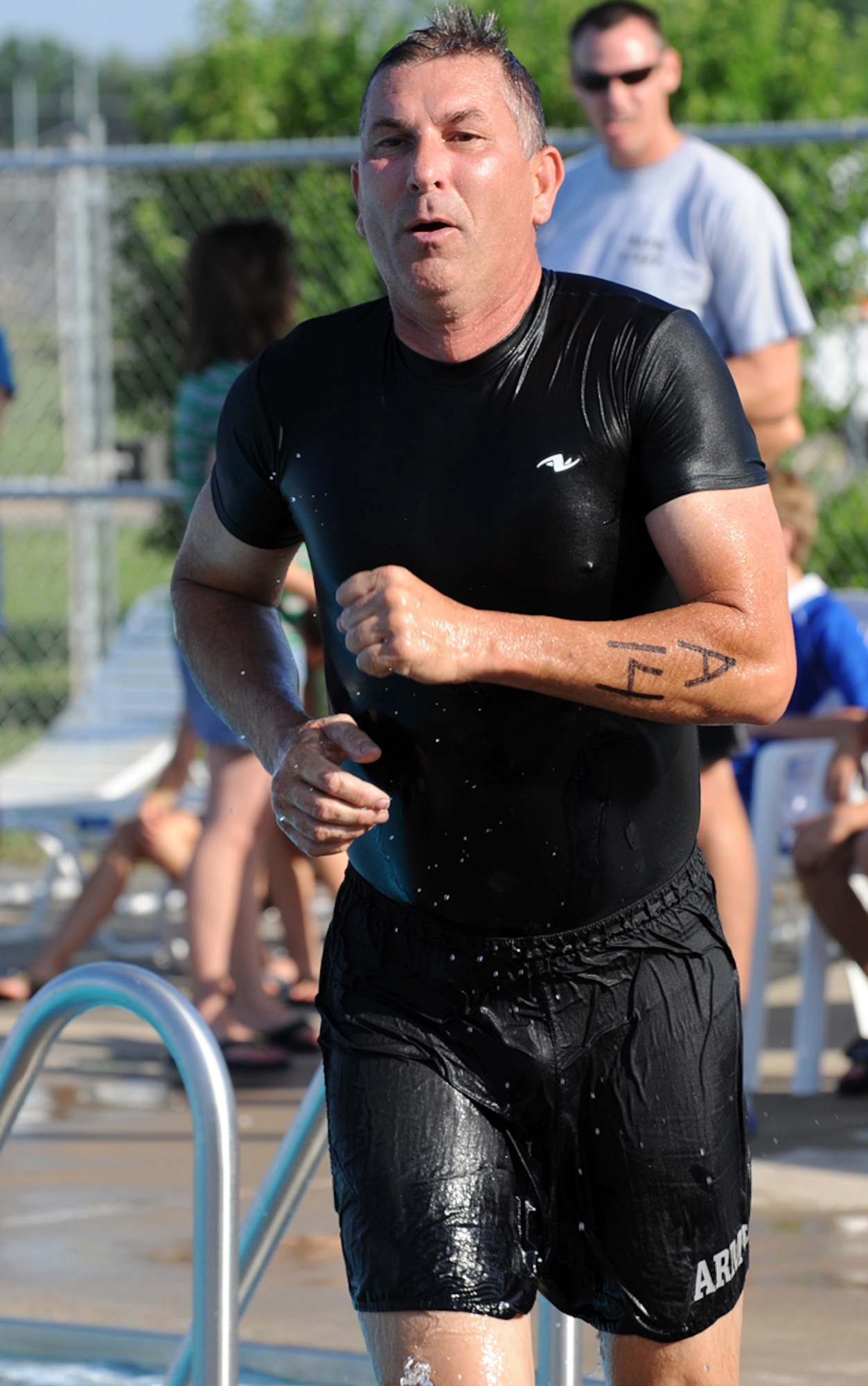WHITEMAN AIR FORCE BASE, Mo. -  Senior Master Sgt. Mark Mock, 442nd Fighter Wing’s Team A, in a fit of urgency, runs out of the pool towards the bike rack to begin the next portion of the triathlon. (U.S. Air Force photo/Senior Airman Cory Todd)