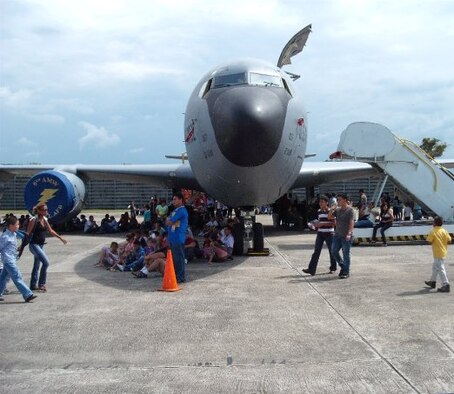 People rest in the shade of a KC-135 Stratotanker at an airshow in Honduras
(U.S. Air Force Photo/unknown)
