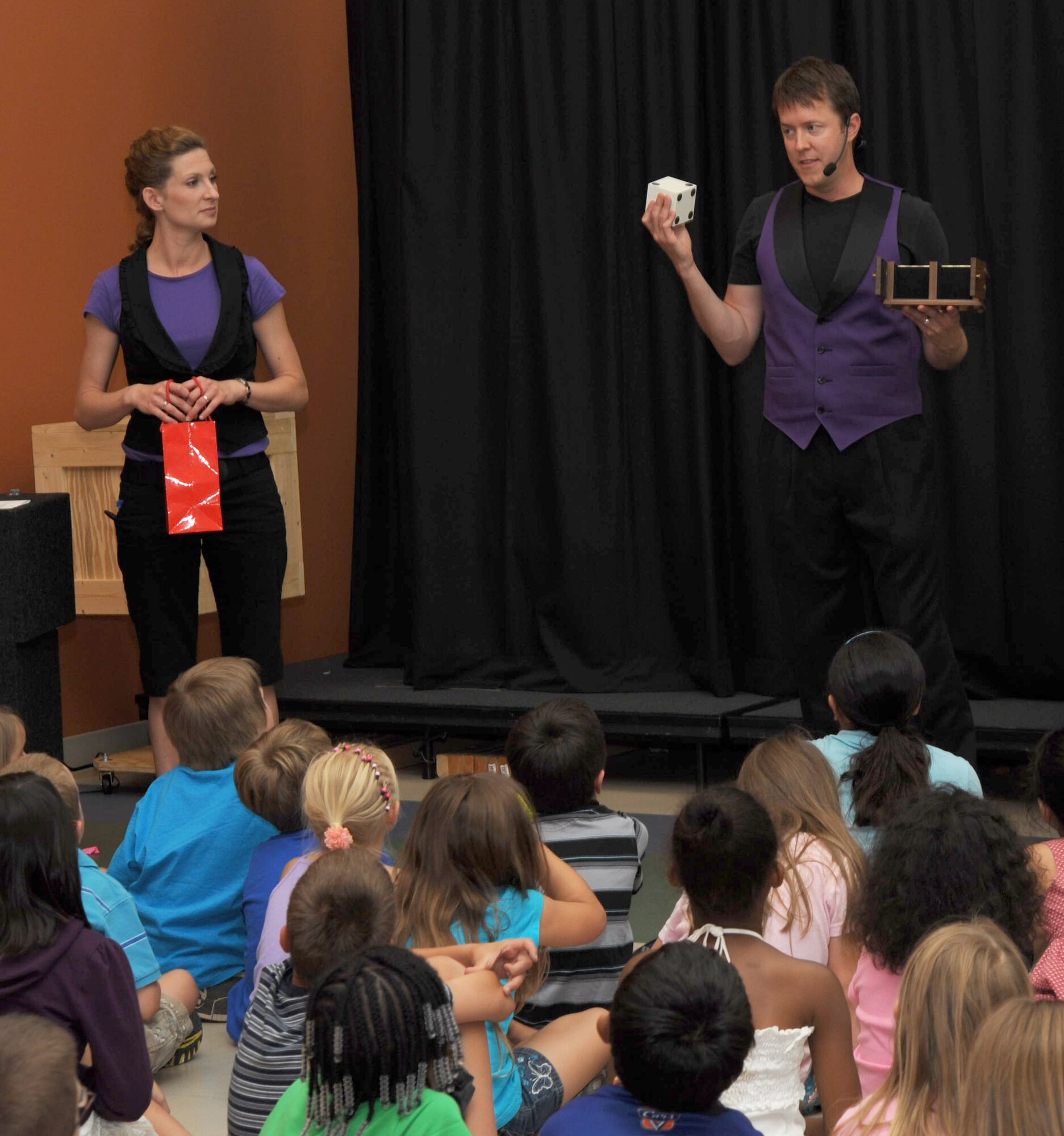 MCCONNELL AIR FORCE BASE, Kan. -- Eric Vaughn and his wife Kelly perform magic tricks for the School Age Program, June 24. The School Age Program has different acts like mimes and magicians to perform for children once a week during the summer months.  (Photo by Senior Airman Roy Lynch) 