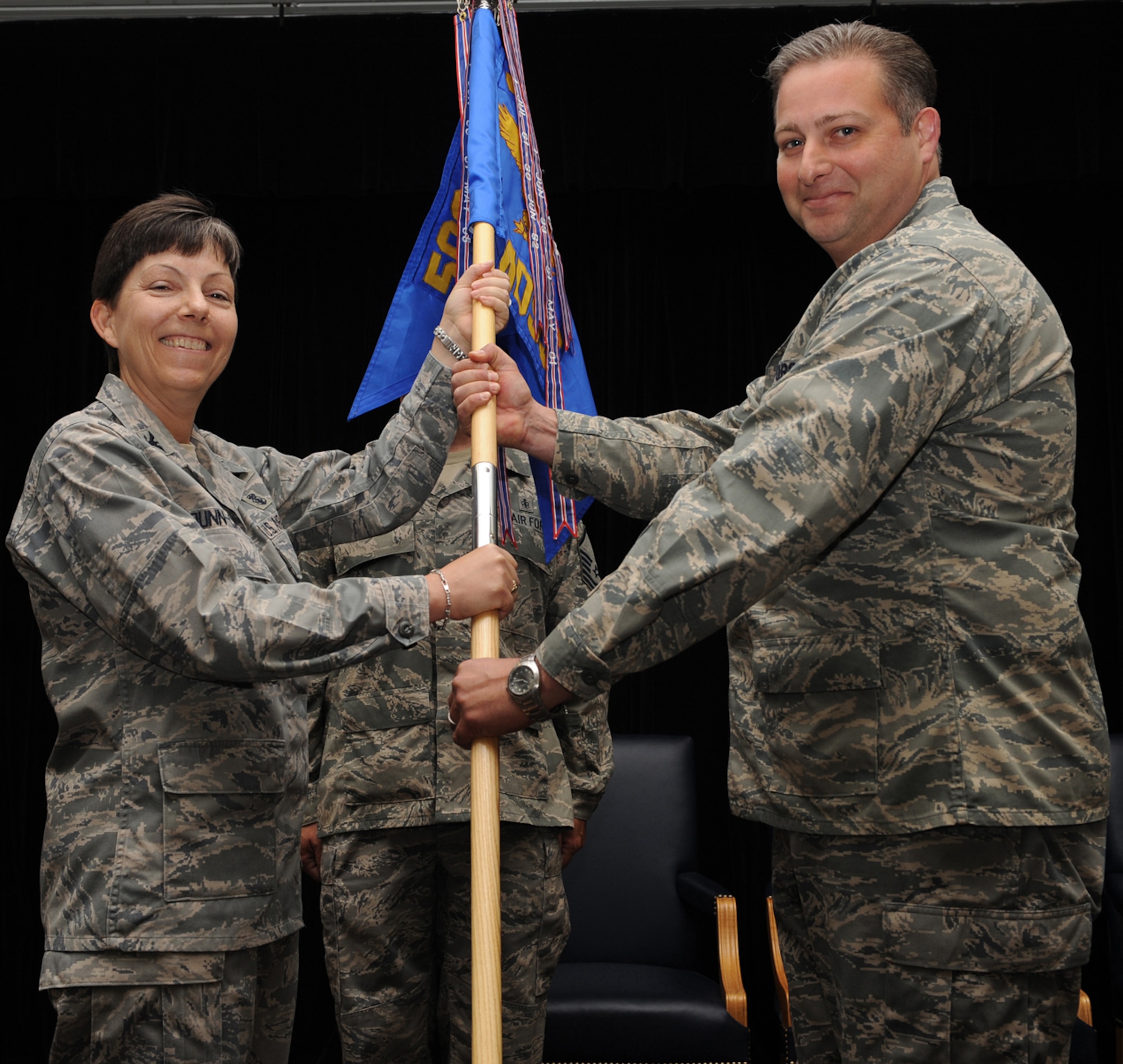 WHITEMAN AR FORCE BASE, Mo. - Lt. Col. Keith Higley receives the 509th Medical Support Squadron guidon from Col. Kathleen Dunn-Cane, 509th Medical Group commander, during a change of command ceremony June 30. Colonel Higley replaces Lt. Col. Matthew Escher as the 509th MDSS commander. (U.S. Air Force photo/Senior Airman Cory Todd)