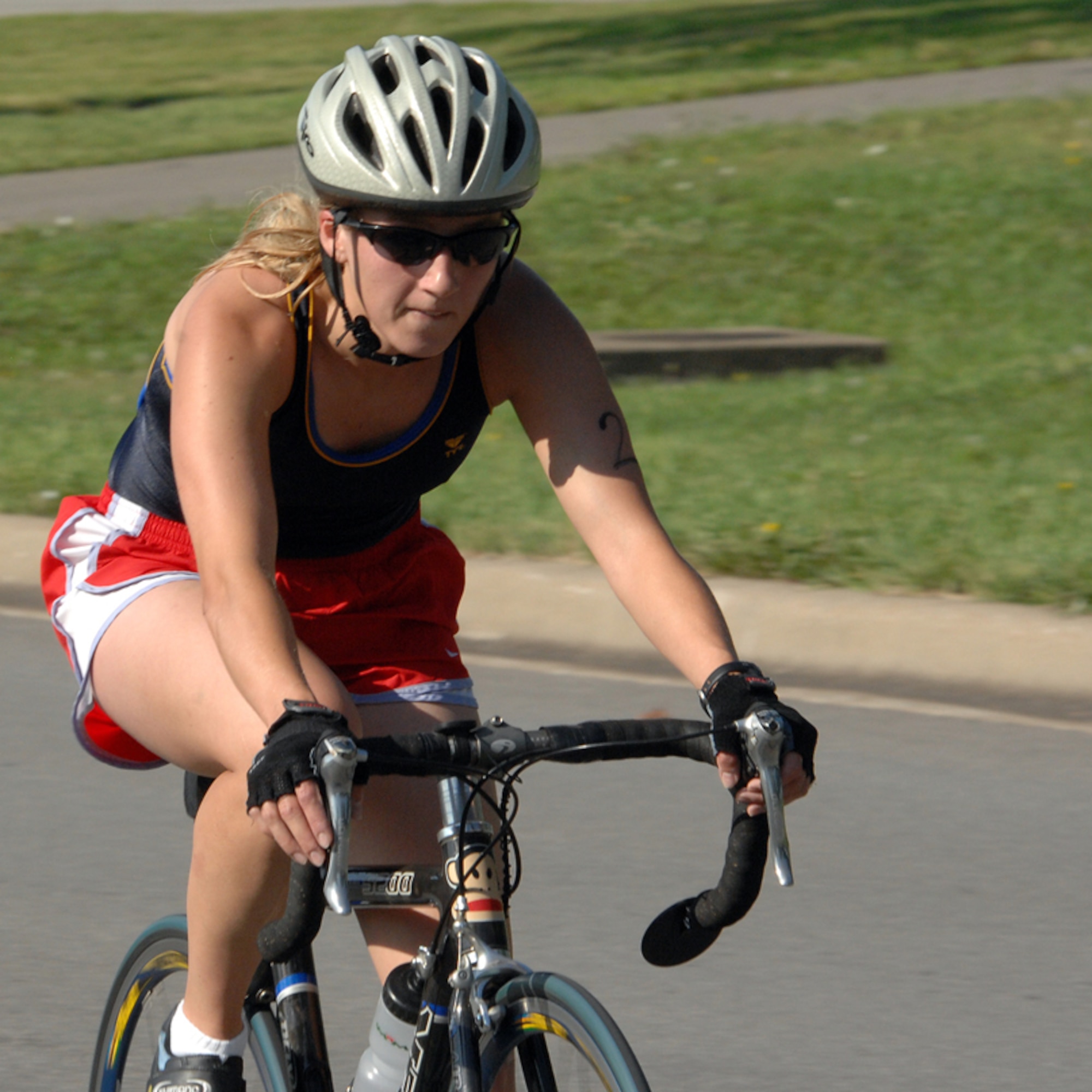 WHITEMAN AIR FORCE BASE, Mo. -  Army Capt.  Kelly Van Veldhuizen,  Army Reserve Military Intelligence Readiness Command, wife of Air Force Capt. Eric Van Veldhuizen, 13th Bomber Squadron, gives that extra something during the return to starting point portion of  the 10K bicycle race during the triathlon.  (U.S. Air Force photo/Master Sgt. Stan Coleman)