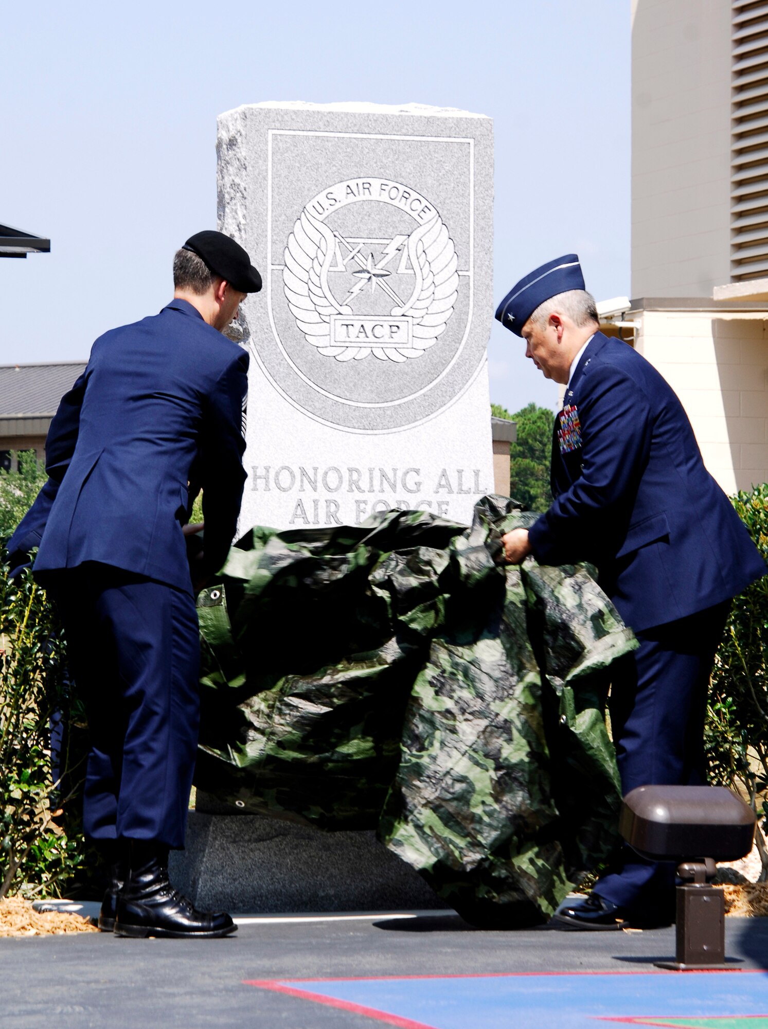HURLBURT FIELD, Fla. --  Chief Master Sgt. David Devine, Headquarters Air Force Tactical Air Control Party career field manager, and Brig. Gen. Michael Longoria, 93rd Air Ground Operations Wing commander, unveil an eight-foot monument June 26 honoring the accomplishments and sacrifices of TACP members past and present. (U.S. Air Force photo/Senior Airman Sheila DeVera)
