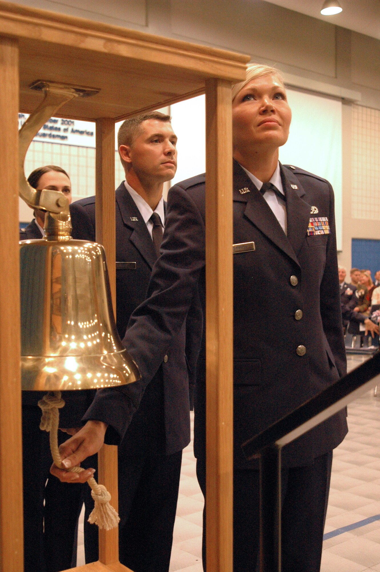 New 2nd Lt. Teah Johnson rings the commissioning bell during her graduation from the Academy of Military Science at the I.G. Brown Air National Guard Training and Education Center at McGhee Tyson Air National Guard Base, Tenn., on June 26, 2009. She will become a navigator on a C-130 cargo aircraft for the 182nd Airlift Wing of the Illinois Air National Guard. Officer candidates of class “O-2009-4,” who graduated today, are members of the last officer commissioning program class at TEC. (Photo by Master Sgt. Greg Rudl, National Guard Bureau)