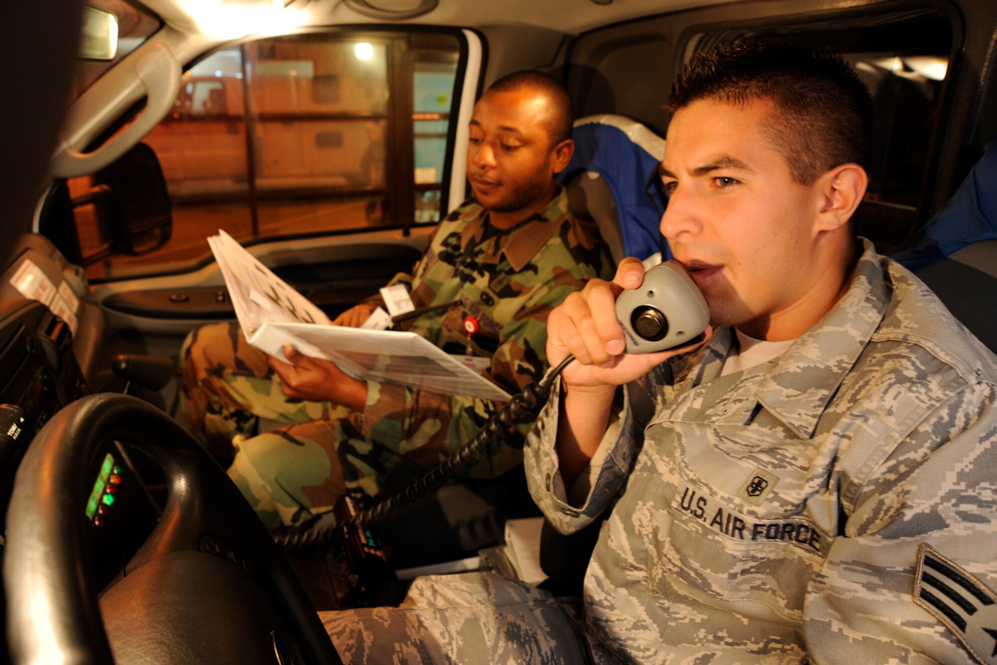 MCCONNELL AIR FORCE BASE, Kan.-- Senior Airman Jonathan Gomez and Staff Sgt. Quinton Sterling, both of 22nd Aerospace Medicine Squadron, conduct a radio check with fire dispatch during a Nuclear Operational Readiness Exercise June 24. (Photo by Tech. Sgt. Chyrece Campbell)