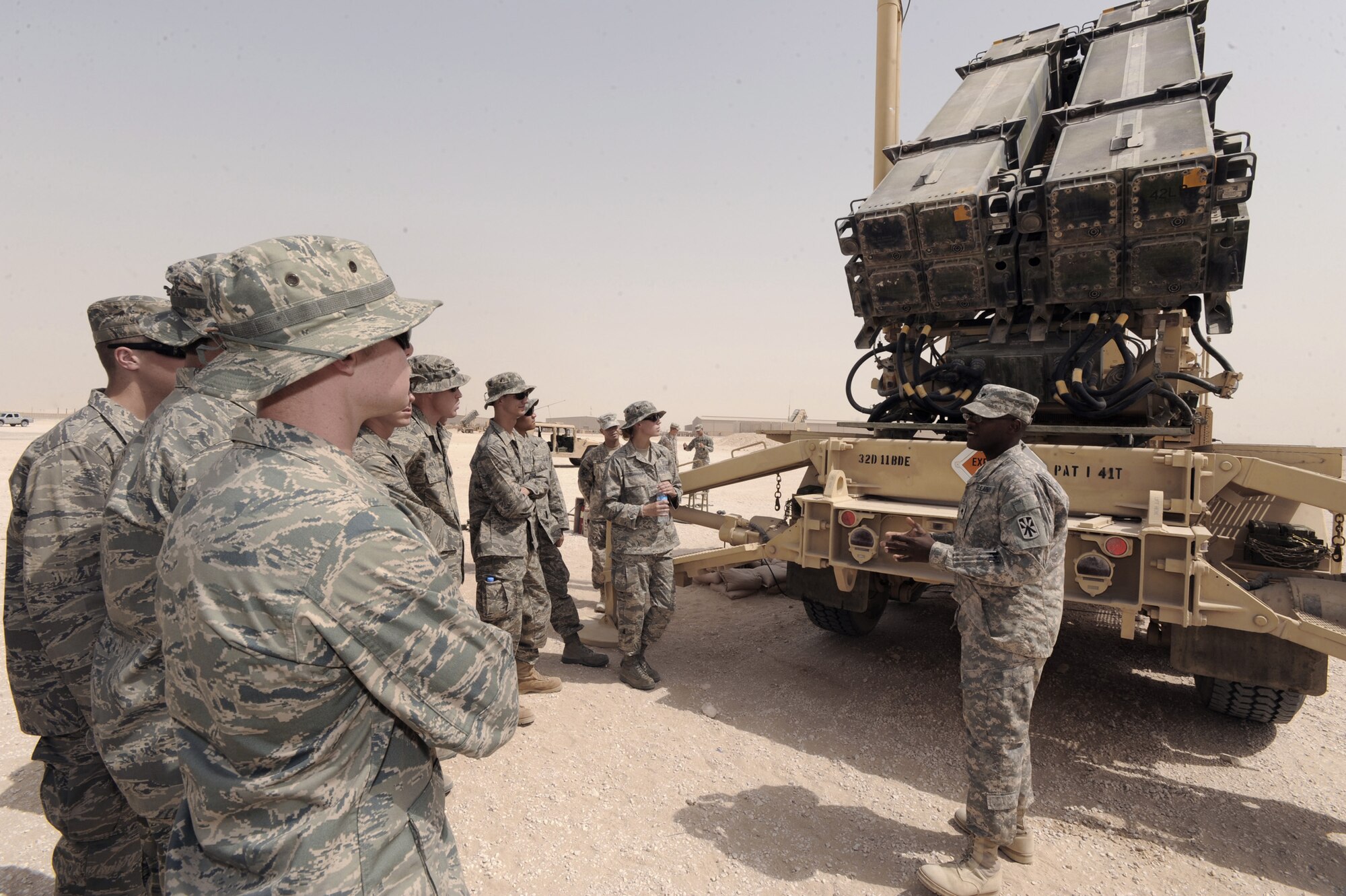 Army Spc. John Dodson briefs U.S. Air Force Academy cadets on the Army mission June 24 at an undisclosed location in Southwest Asia. The cadets are part a program called Operation Air Force, which gives them exposure to the operational side of the Air Force and deployed locations before being commissioned. (U.S. Air Force photo/Staff Sgt. Joshua Garcia) 