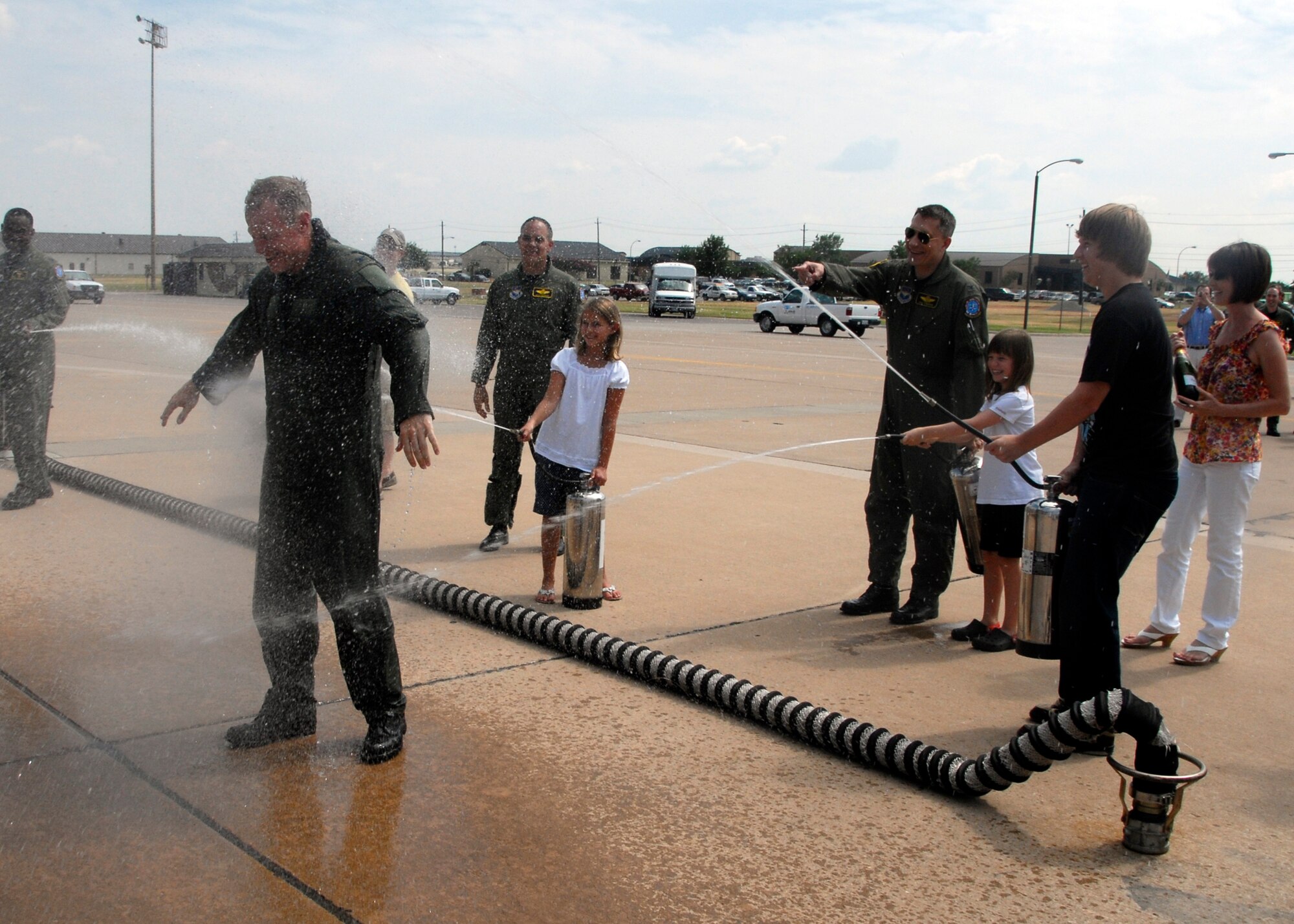 Col. David Petersen, center, gets hosed down by family and friends June 30 following his final flight as commander of the 80th Flying Training Wing. The colonel has commanded the wing and the Euro-NATO Joint Jet Pilot Training Program since August 2007. His next assignment will be in Brussels, Belgium, as the Deputy United States Military Representative to North Atlantic Treaty Organization Military Committee. (U.S. Air Force photo/Mike Litteken)