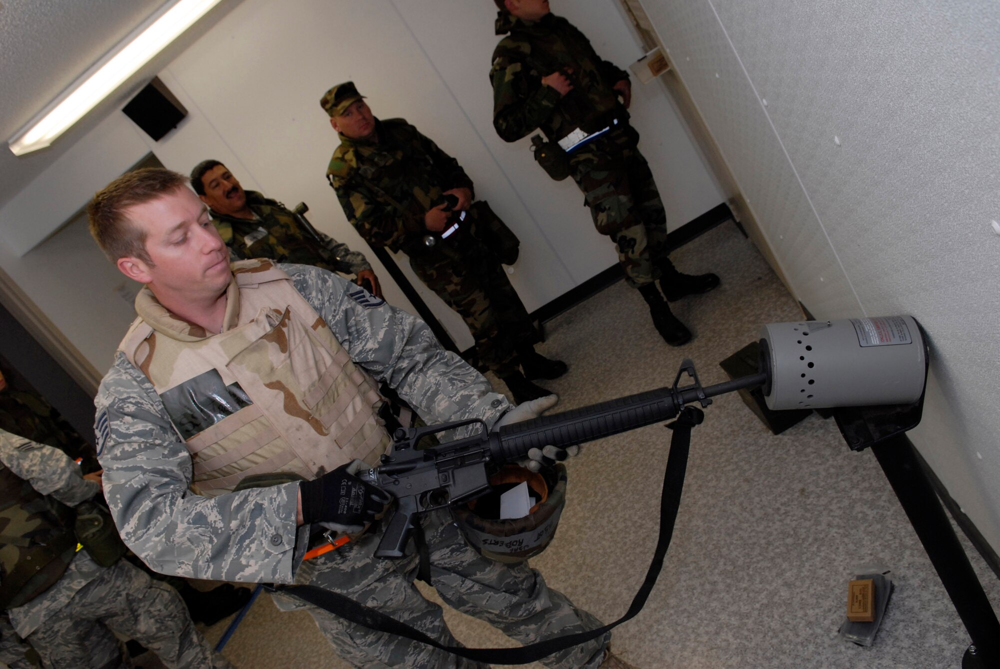 Security Forces augmentees during an exercise at Volk Field, Wisconsin each wait their turn at the clearing barrel with their M-16s.  Hundreds of men and women from the Minnesota Air National Guard unit joined others from Scott Air Force Base, Illinois for Readiness Safeguard in preparation for an Operational Readiness Inspection. USAF Official photo by Technical Sgt. Erik Gudmundson.(Released)