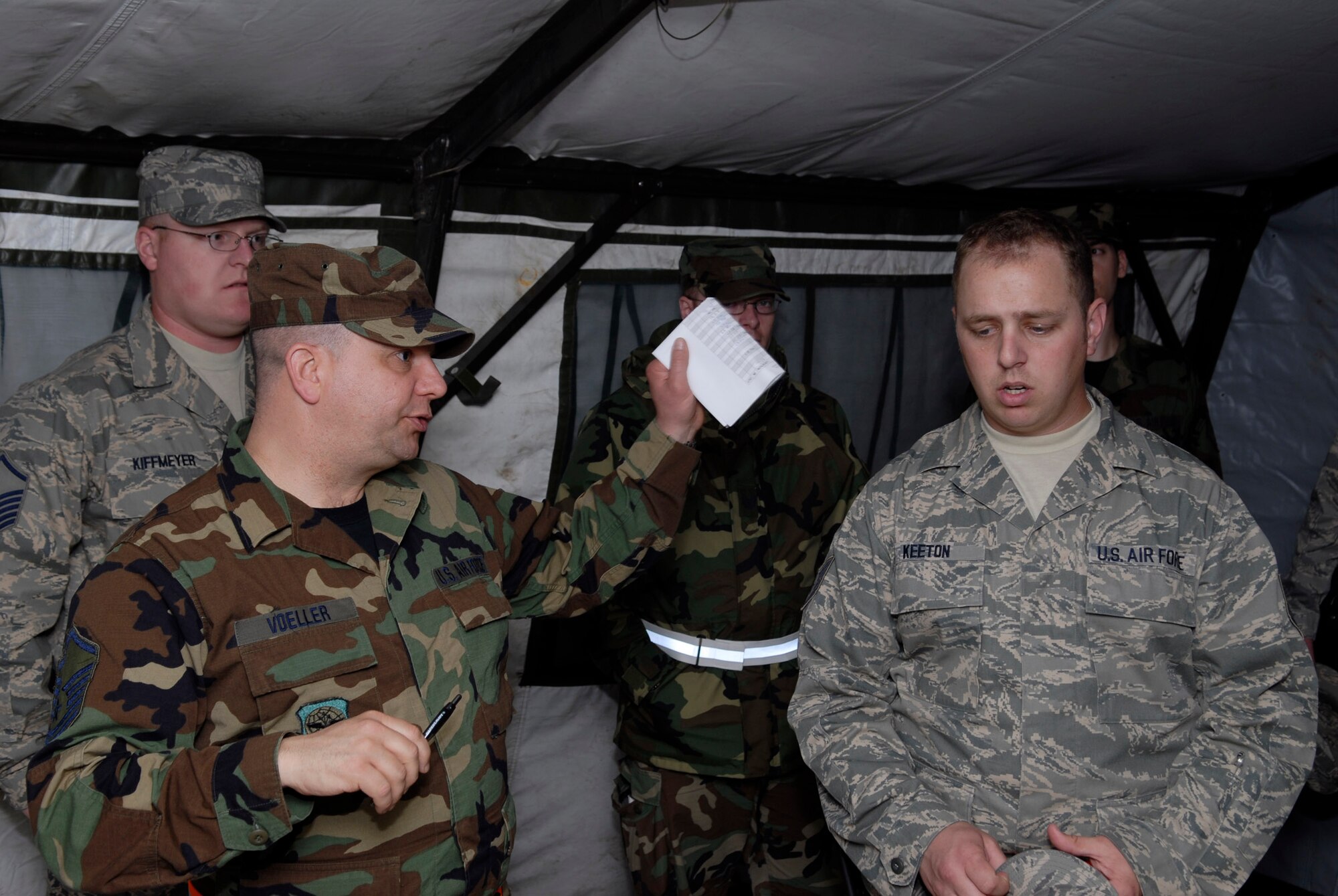 Airmen of the 133rd Airlift Wing meet in a tent simulating a bunker during a training mission at Volk Field, Wis. on May 15, 2009. Hundreds of men and women from the Minnesota Air National Guard unit joined others from Scott Air Force Base, Illinois for Readiness Safeguard in preparation for an Operational Readiness Inspection. USAF Official photo by Technical Sgt. Erik Gudmundson.(Released)