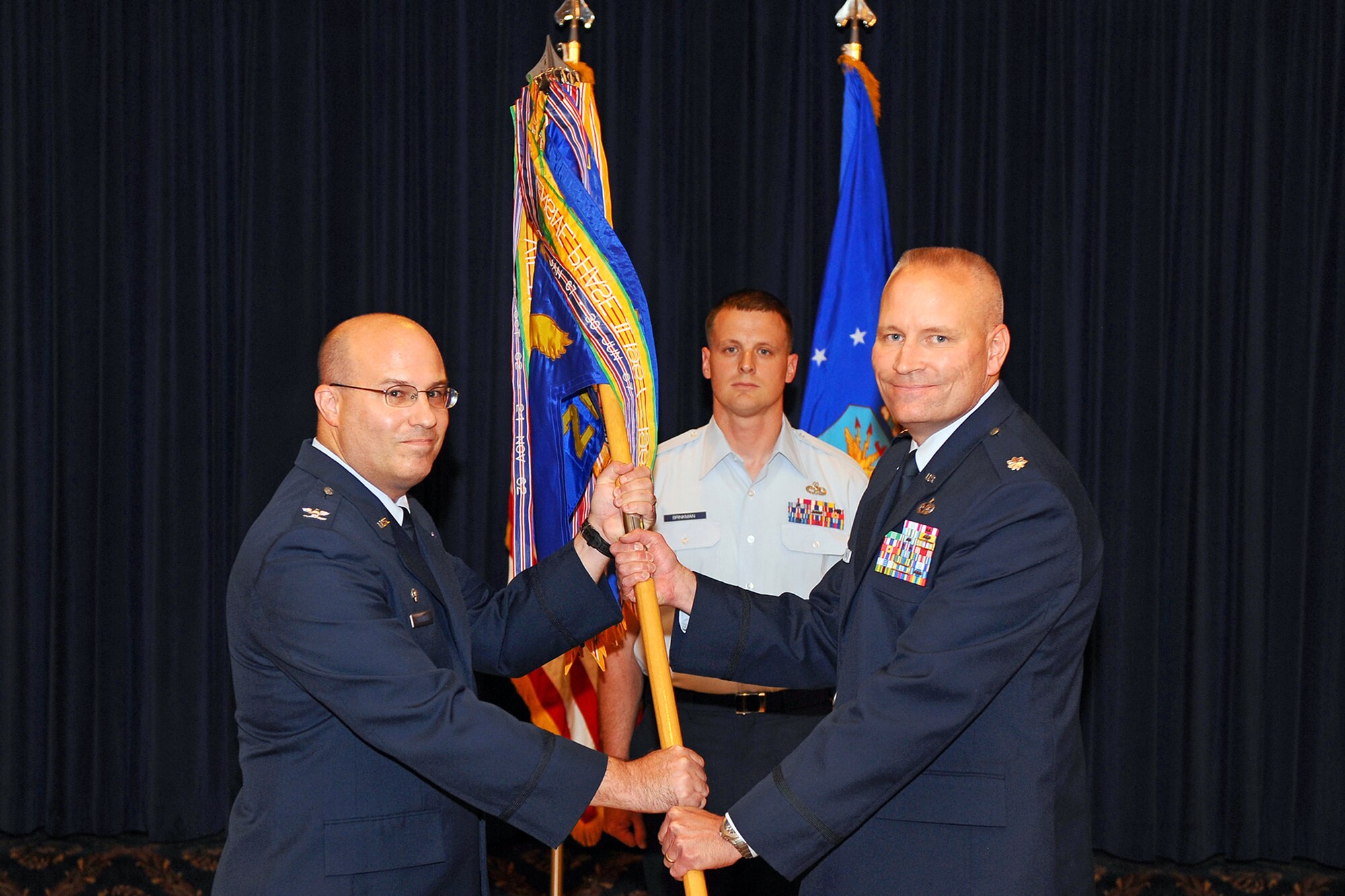 OFFUTT AIR FORCE BASE Neb.,-- Colonel Phillip Pratzner Jr., ACC Combat Targeting Intelligence Group commander, passes the 20th Intelligence Squadron's guidon to Lt. Col. Jeffrey Dyball during his assumption of command at the Patriot Club June 26.  Lt. Col. Dyball is replacing Lt. Col. Peter Bailey who was unable to attend due to deployment.

U.S. Air Force Photo by Josh Plueger

