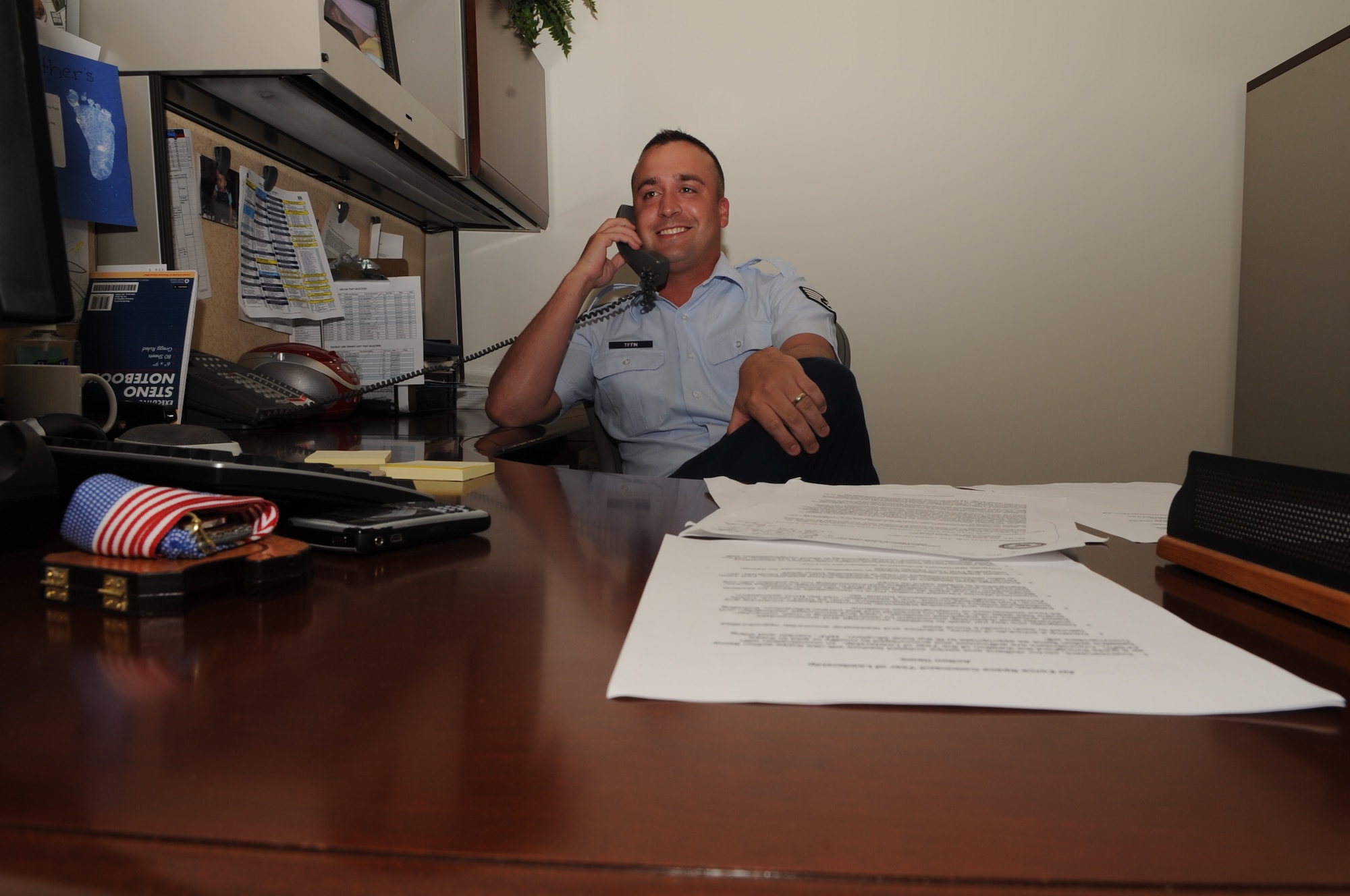 BUCKLEY AIR FORCE BASE, Colo. -- Staff Sgt. Justin Tiffin, Executive Assistant to the 460th Space Wing Command Chief, tends to a phone call here.  Sergeant Tiffin is Team Buckley’s Warrior of the Week for July 3-July 10 and has served in the Air Force for over eight years. (U.S. Air Force photo by Senior Airman Randi Flaugh)