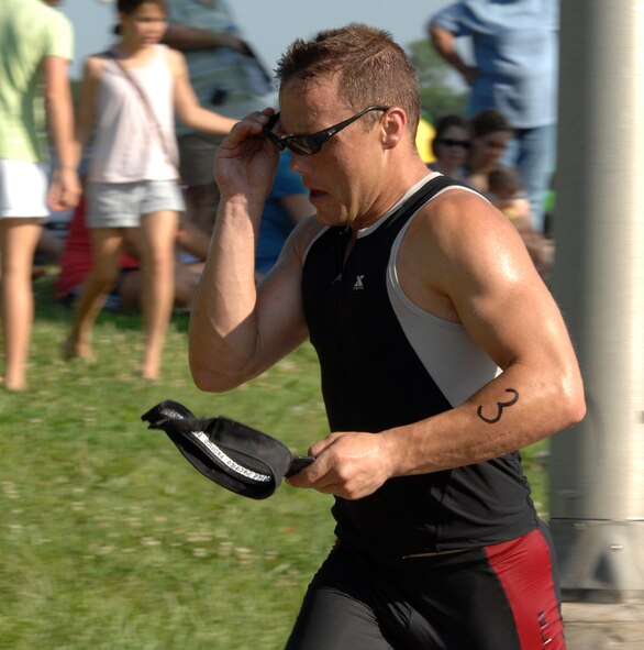 WHITEMAN AIR FORCE BASE, Mo. - Staff Sgt. Brian Frank, 509th Logistics Readiness Squadron  dons his running shades and visor during the 5K run portion of the  Whiteman Fitness Center  Triathlon.  Sergeant Frank placed first in with 45 minutes and 17 seconds in overall time.  (U.S. Air Force photo/Master Sgt. Stan Coleman)