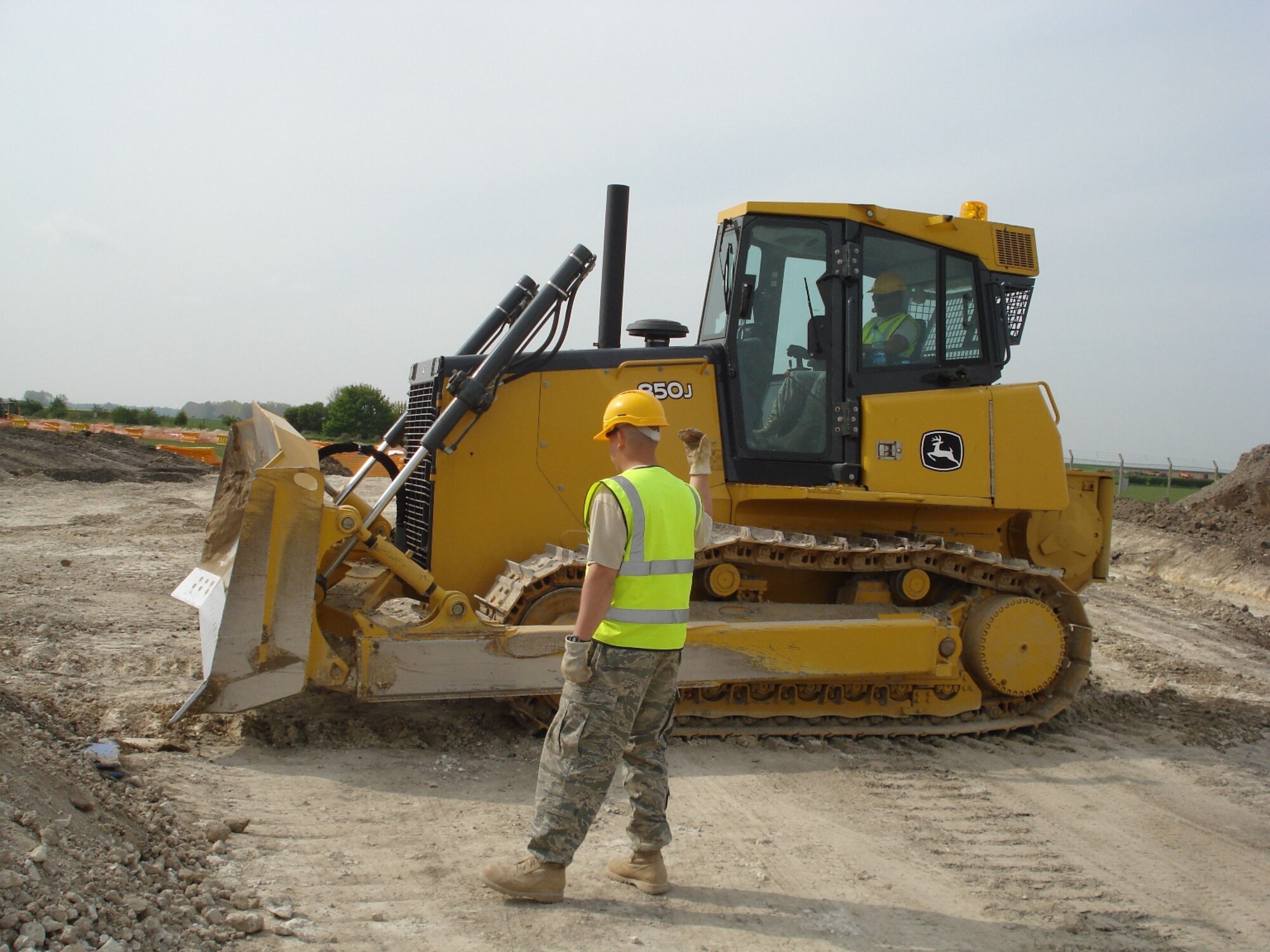 RAF FELTWELL, England--TSgt Lamont Hall, NCOIC, Electrical Systems, 86th Construction and Training Squadron Military Construction Flight, and SSgt Bobby Martin, Pavements & Equipment Operator, 86th CTS/MCF operate a bulldozer during construction of a road on the installation.  Every civil engineering trade gains experience on all heavy equipment at RAF Feltwell. (USAF photo)
