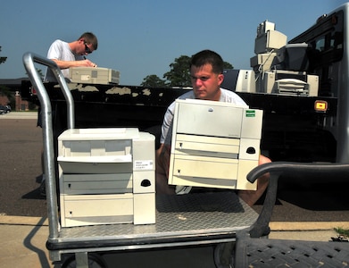 Staff Sgt. James Davis and Airman 1st Class Michael Pitts deliver printers from the 17th Airlift Squadron to the automated data processing storage facility here June 29. The ADPE facility is the base focal point for computer technology asset issues, turn-in and manages more than 250 asset accounts base wide. Sergeant Davis is the ADPE monitor for the 17 AS and Airman Pitss is a loadmaster with the 17 AS.