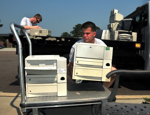 Staff Sgt. James Davis and Airman 1st Class Michael Pitts deliver printers from the 17th Airlift Squadron to the automated data processing storage facility here June 29. The ADPE facility is the base focal point for computer technology asset issues, turn-in and manages more than 250 asset accounts base wide. Sergeant Davis is the ADPE monitor for the 17 AS and Airman Pitss is a loadmaster with the 17 AS.