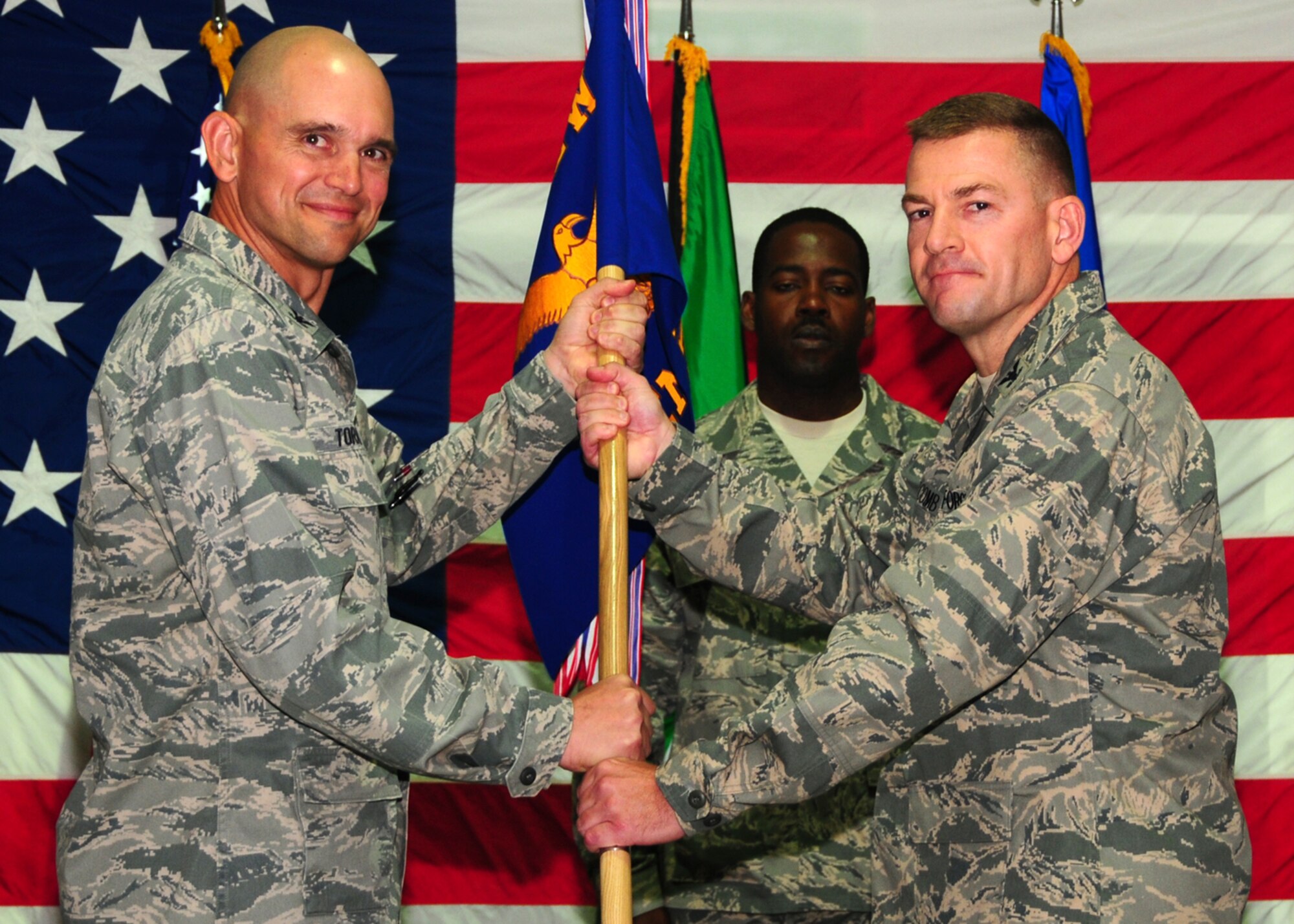 SOUTHWEST ASIA -- Col. Richard McComb recieves command of the 386th Expeditionary Mission Support Group from Col. Cameron Torrens , 386th Air Expeditionary Wing commander, at an air base in Southwest Asia, June 30. (U.S. Air Force photo/Senior Airman Courtney Richardson)