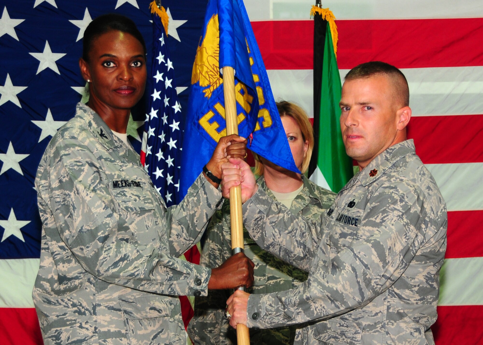 SOUTHWEST ASIA -- Maj. Chad Morris assumes command of the 386th Expeditionary Logistic Readiness Squadron from Col. Marcia Meeks-Eure, 386th Expeditionary Mission Support Group commander, at an air base in Southwest Asia, June 29.(U.S. Air Force photo/Senior Airman Courtney Richardson)