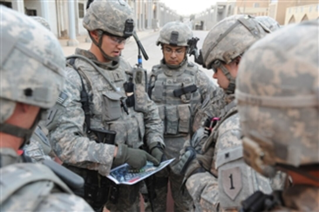 U.S. Army 1st Lt. Seth Sanert with Delta Company, 1st Battalion, 18th Infantry Division goes over the scheme of maneuver with his troops, in Baghdad, Iraq, on June 25, 2009.  