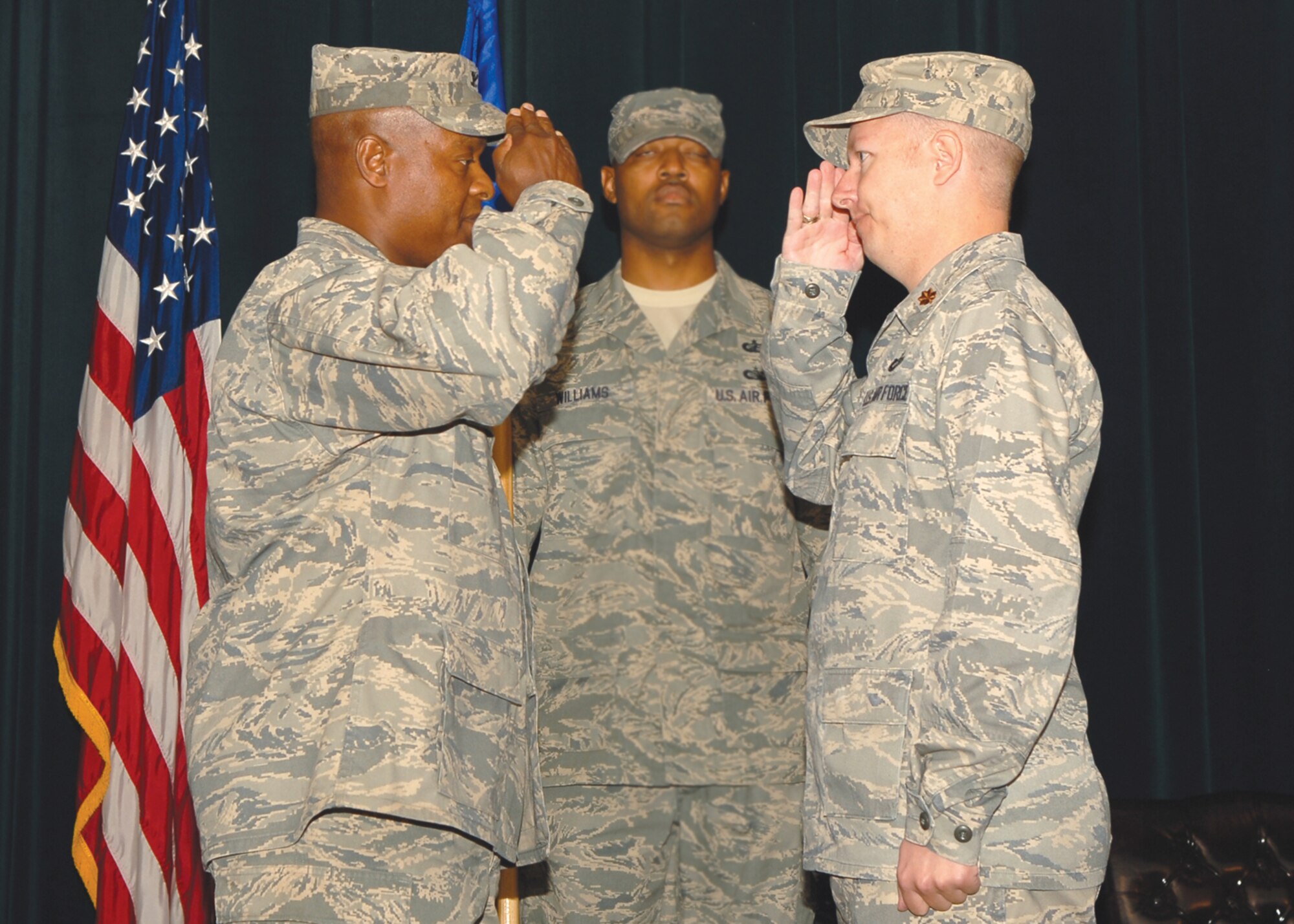 Reviewing officer Col. Andre Curry, 56th Mission Support Group commander, salutes incoming commander, Maj. Tommy Gates III, 56th Contracting Squadron commander, during the 56th Contracting Squadron change-of-command held at the Desert Star Tuesday. (U.S. Air Force photo/ Airman 1st Class Ronifel Yasay)
