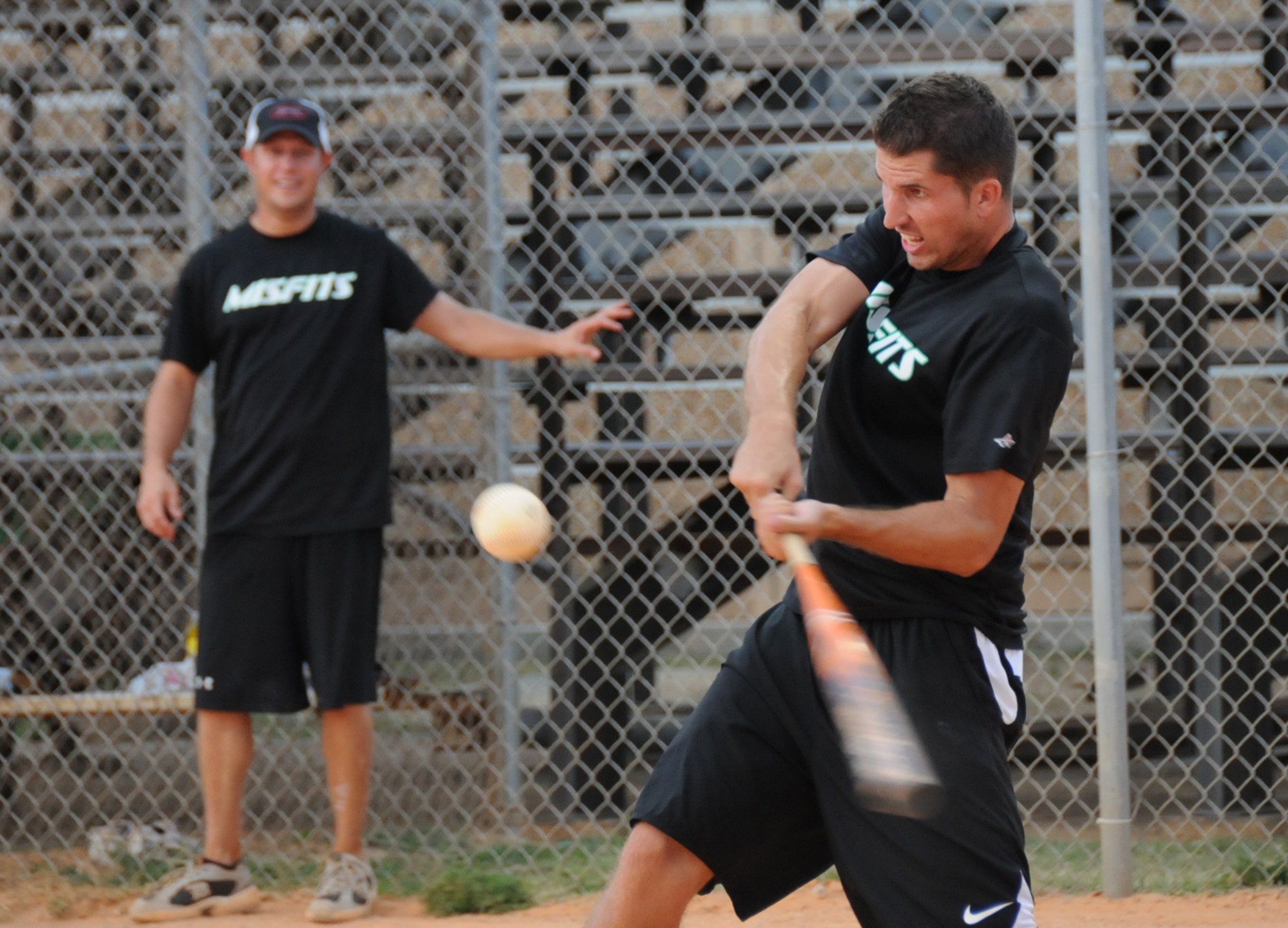 Jason Hutchison waits on deck as his Misfits teammate, Ryan Rice, gets a hit during the championship game.  The Misfits kept the hits going for a 21-7 win.  (U.S. Air Force photo by Kemberly Groue)