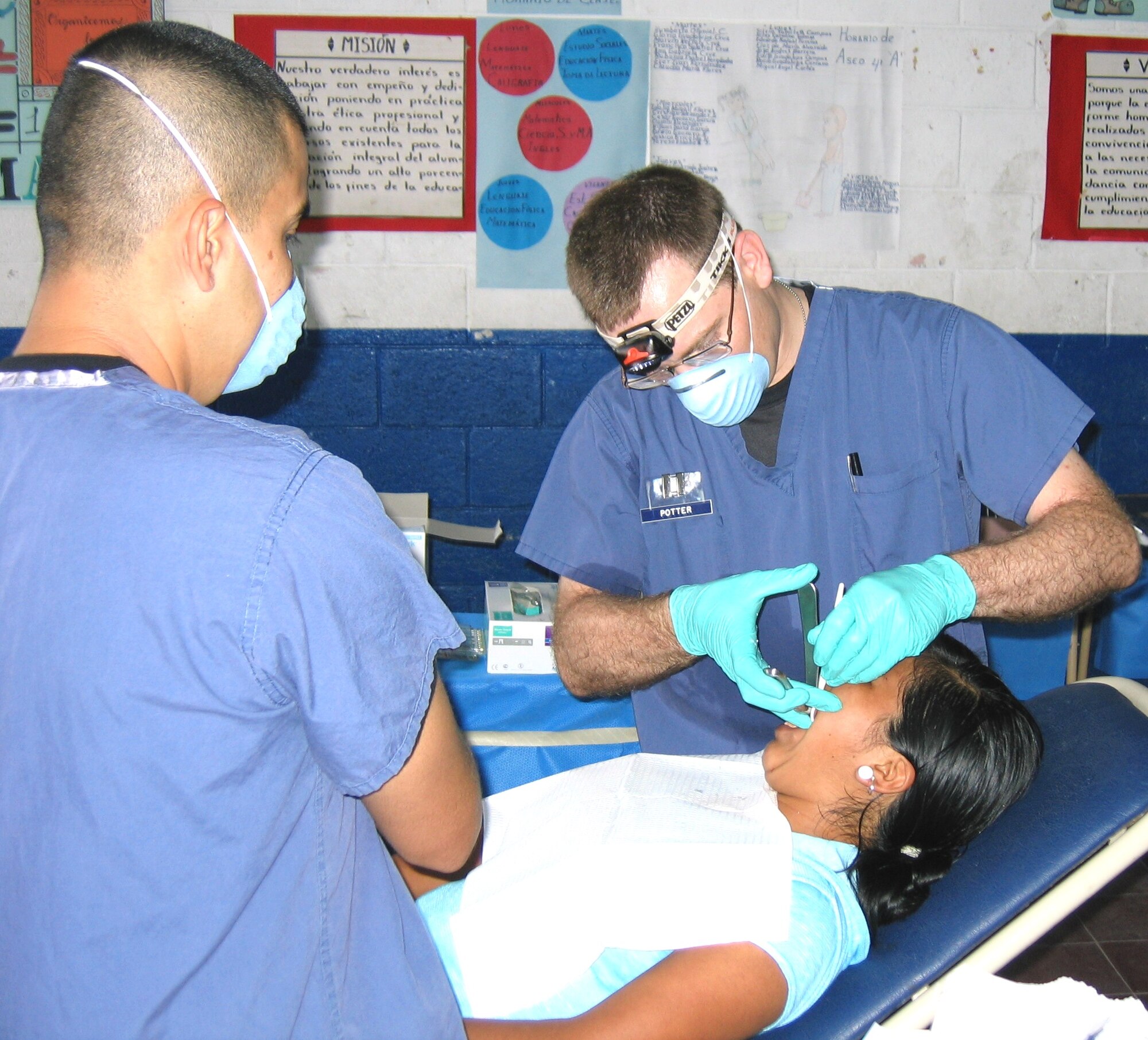 Airman Quijano assists Capt. (Dr.) Stephen Potter from Columbus AFB in treating a dental patient.  (Courtesy photo)